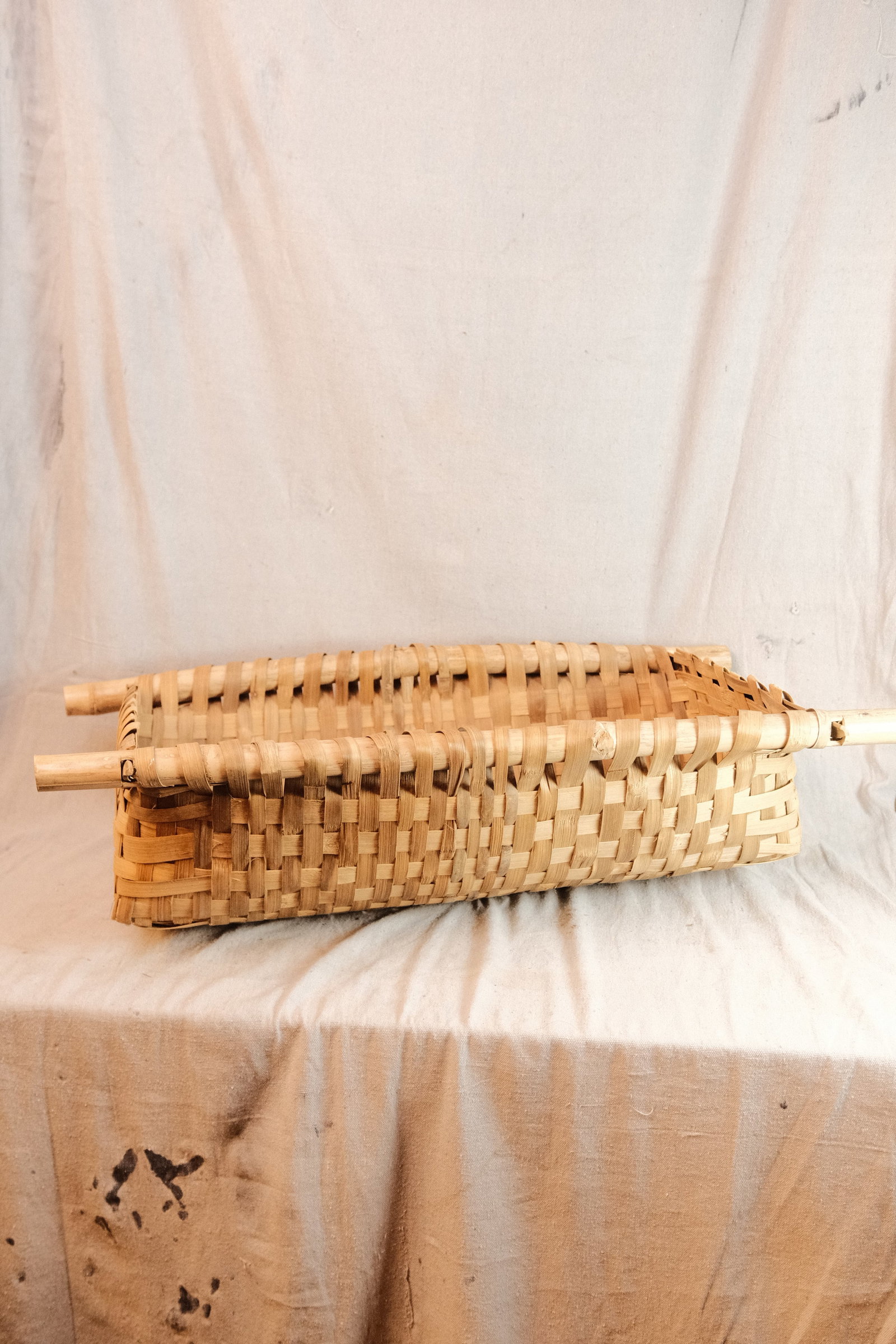 Handwoven Rustic Basket in natural finish: Rustic Hand woven Elongated Basket with Wood Support Handles in Natural Finish