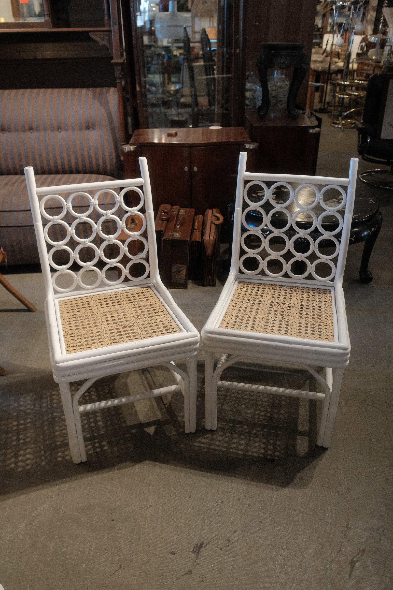 White Wicker and Rattan Chair: Bright White dining chair with circular accents, and rattan woven seat.