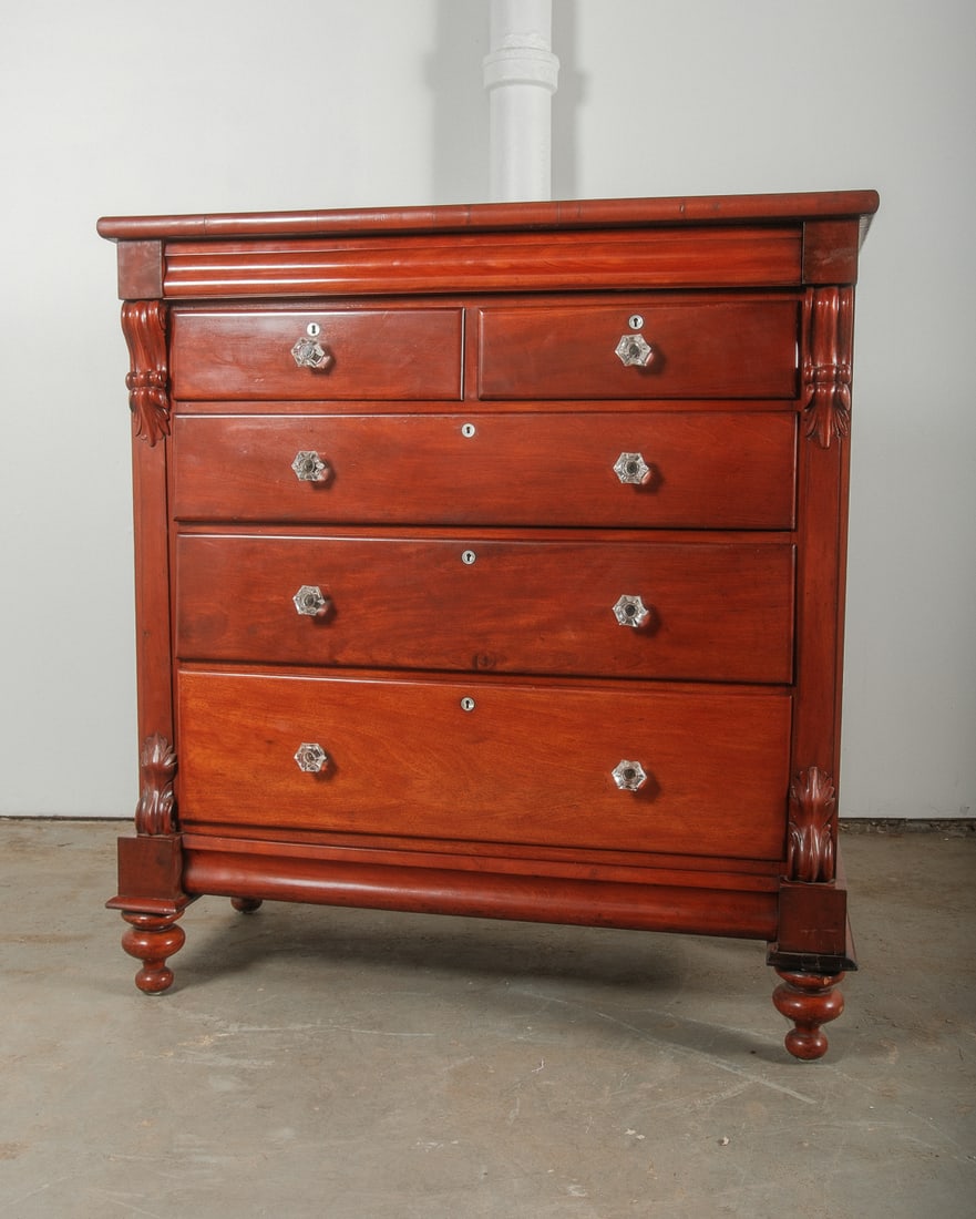 Mahogany Gentleman's or Bachelor Bureau: Mahogany Gentleman's Bureau with waved acanthus leaf and scroll applied cornice and baluster details. The Bachelor dresser has original glass drawer pulls and turned bun feet. The buffed finish only h