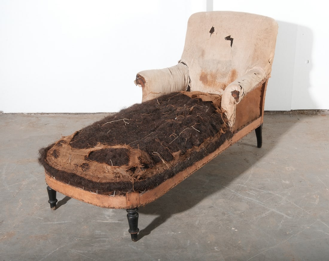 Chaise Lounge Chair Upholstered Frame: Raw, un-upholstered Chaise Lounge wood frame with original batting and stuffing. Lounge base has remnants of muslin cover, raw cushion stuffing visible. Chair has original batting cover.