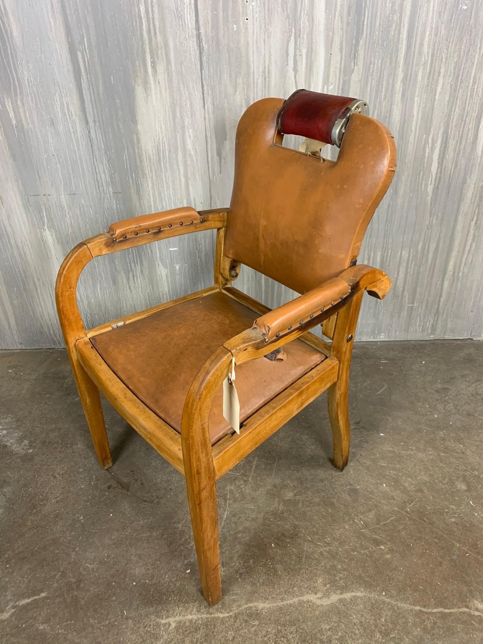 Antique Barber Chair: A 1920's antique reclining barber chair and adjustable head rest.