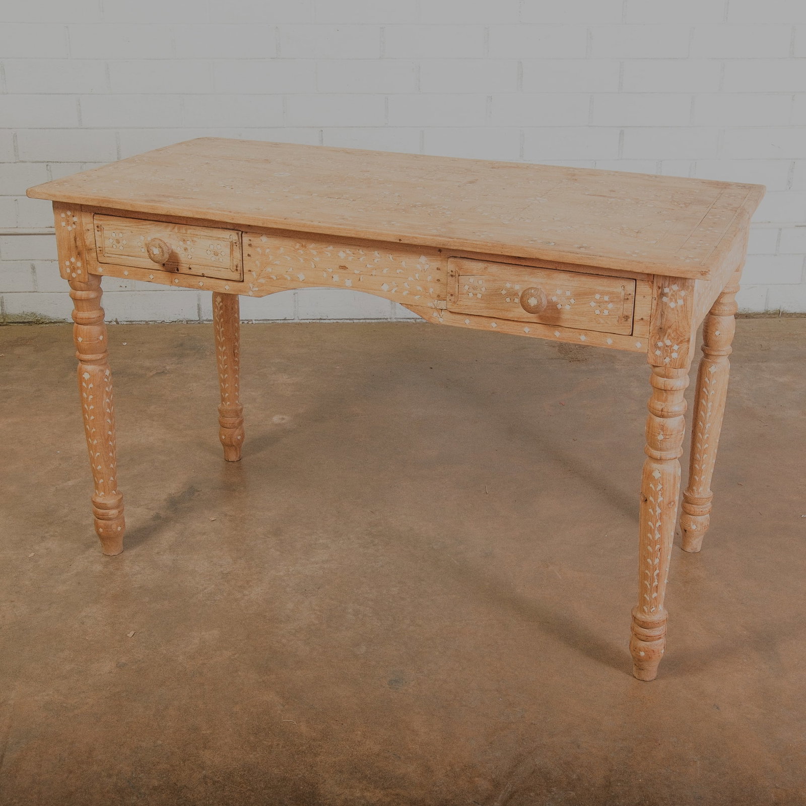 Anglo Indian Bone Inlay Wood Desk: Anglo Indian Bone inlay wooden desk. This rectangular desk had side by side pull out drawers and sits on four beautifully hand tooled pedestal legs. The delicate vine/plant bone inlay design is throug