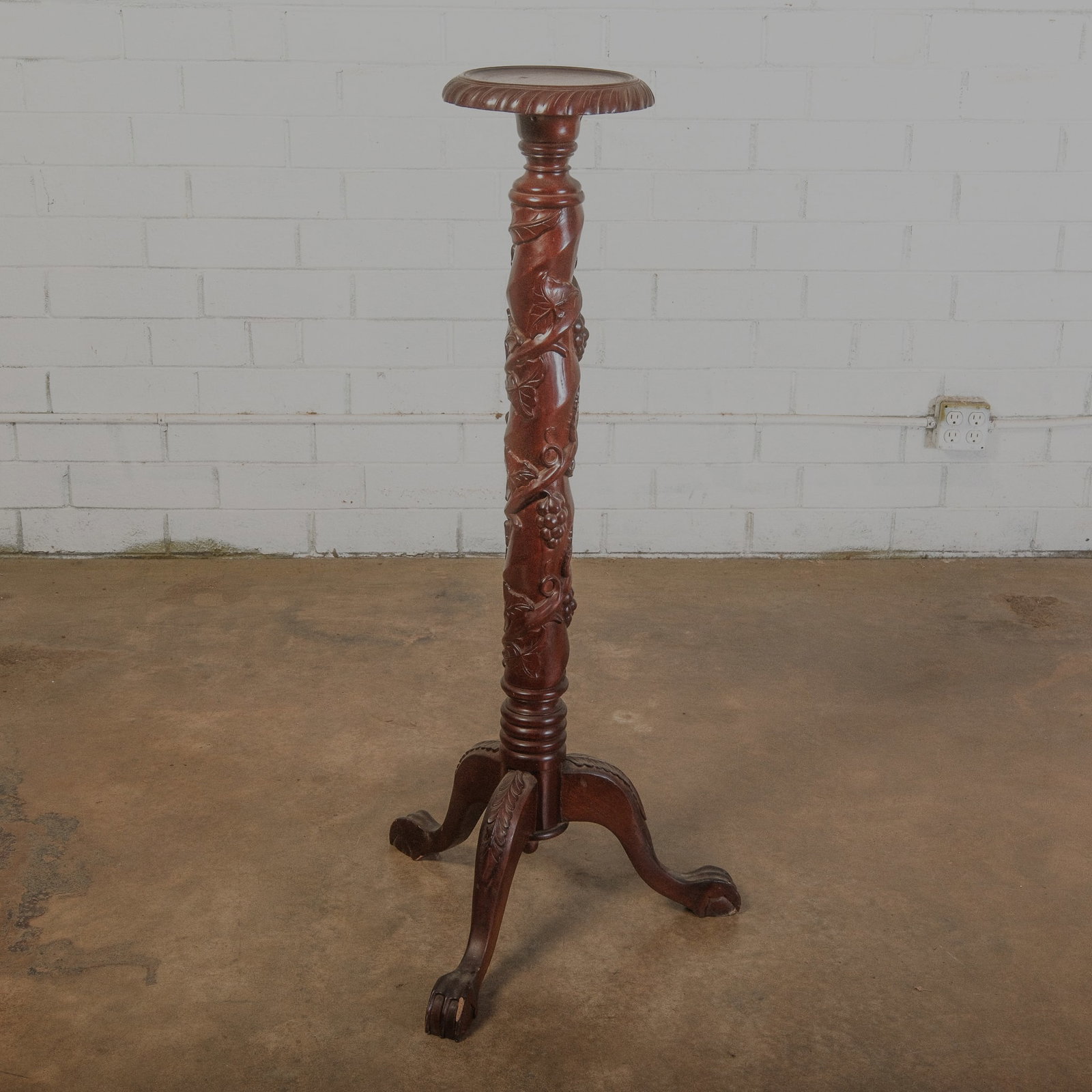 Victorian Hand Carved Plant Stand: Antique Victorian Plant stand on a tri pod base. Center ballister has beautiful hand carved grape vines carved throughout. The top has a delicate 10 inch wooden center plateau and has a carved rope ed