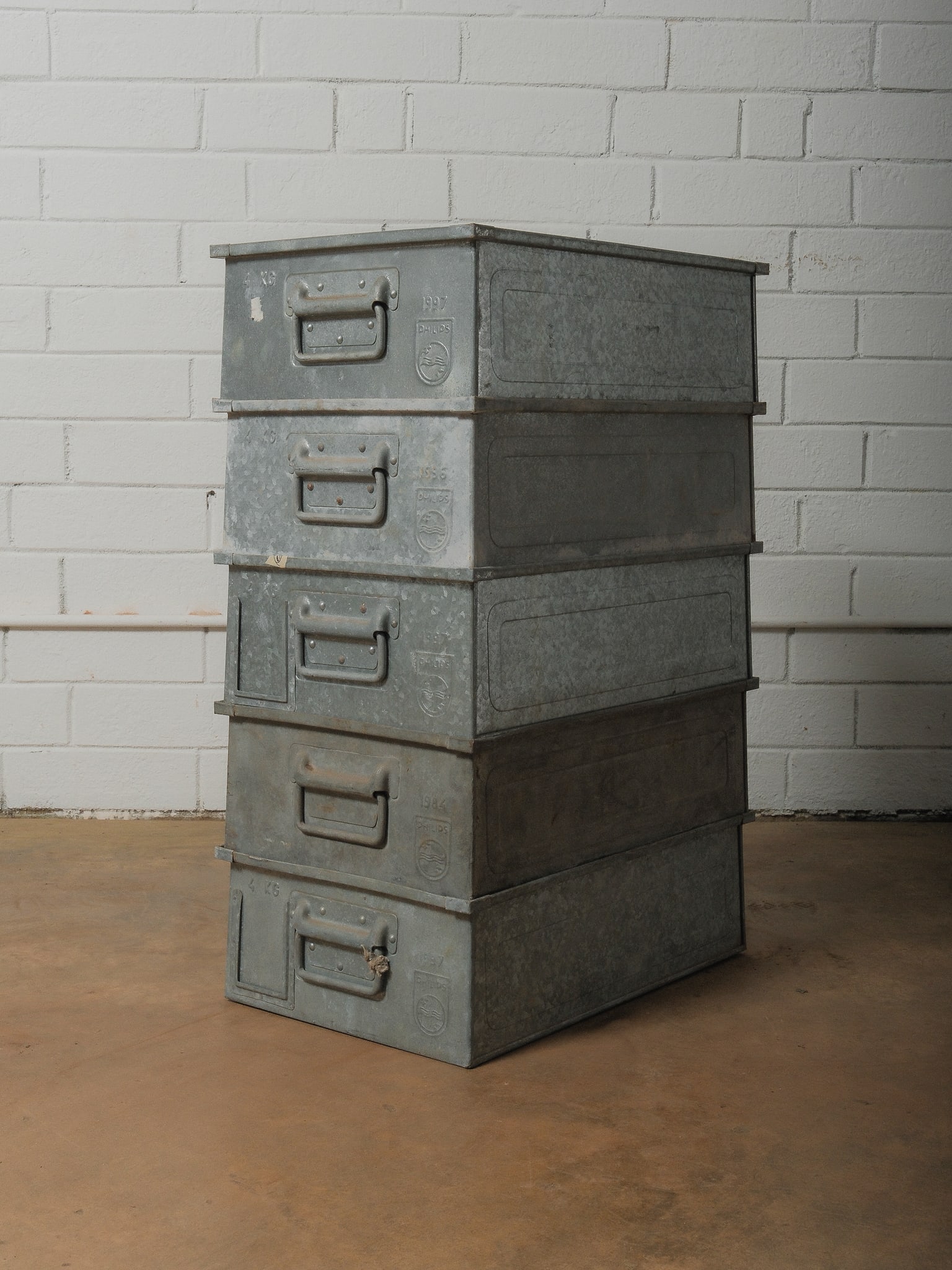 Set of 5 Philips Galvanized Crates: Five matching galvanized industrial crates stamped by Philips. Excellent as storage or display accents.
