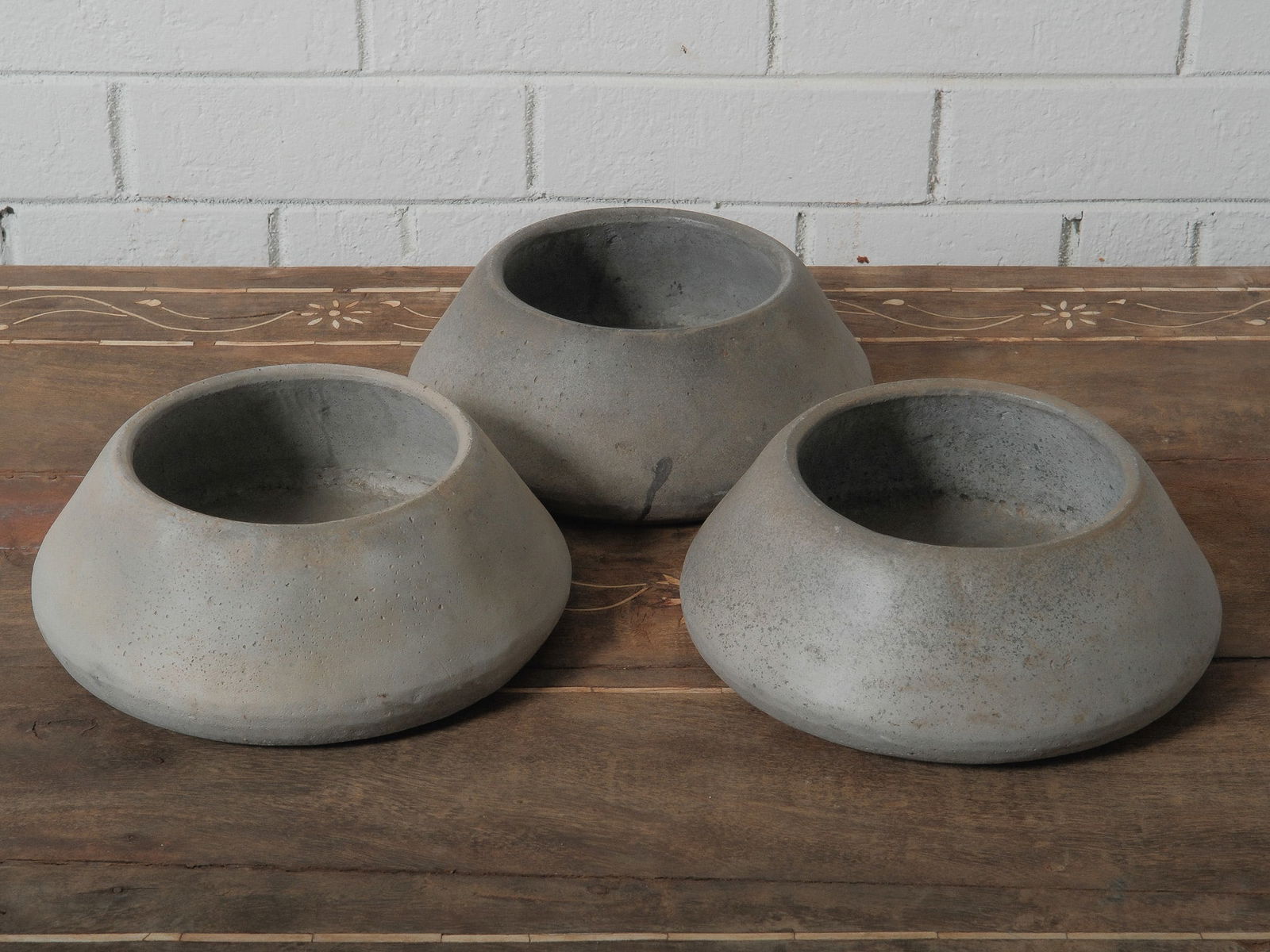 Trio of Wide-Form Clay Bowls: Three clay bowls with thick walls and broad openings. Minimal, sculptural shapes perfect for interiors or garden display.