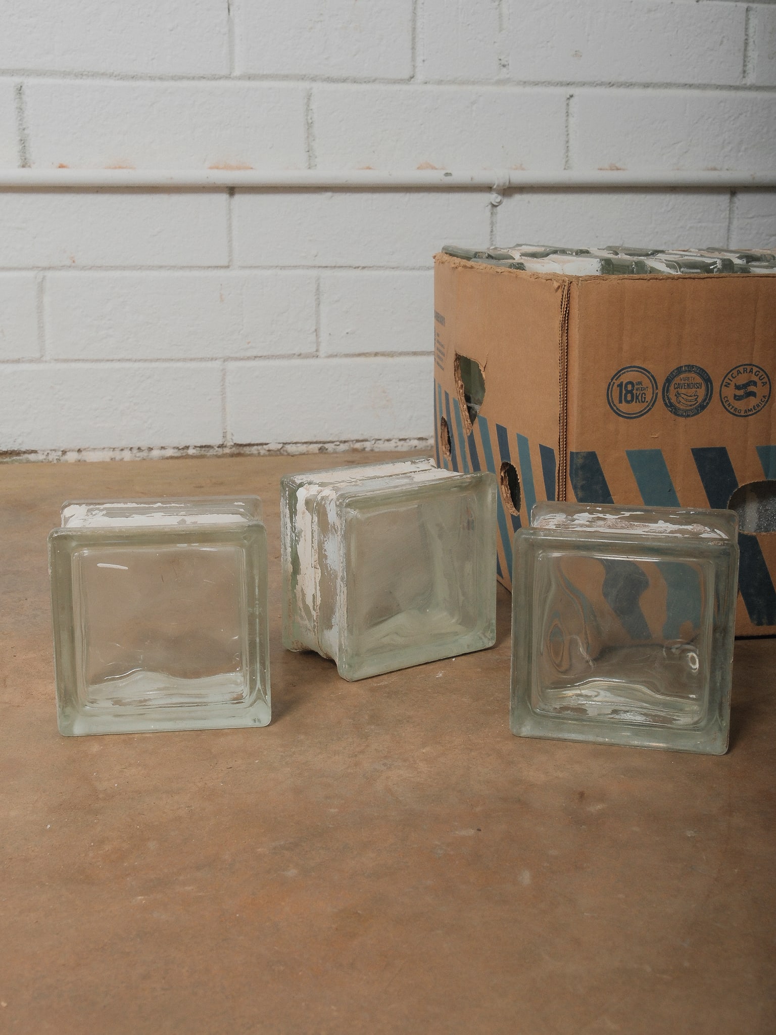 Vintage Clear Glass Architectural Blocks: Group of 36 clear glass building blocks with aged paint remnants. Great for decorative stacking or architectural accent use.