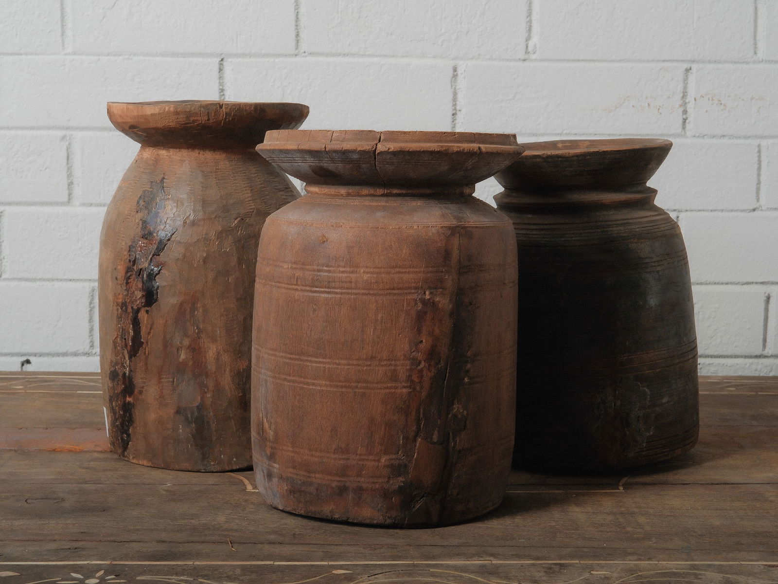 Lot of Three Hand-Carved Wooden Himachal Jars: Hand-carved from a single solid piece of wood, these deceptively simple wooden vases are objects of timeless beauty and elegance. Originating from the Himachal Pradesh region of India, they are expert