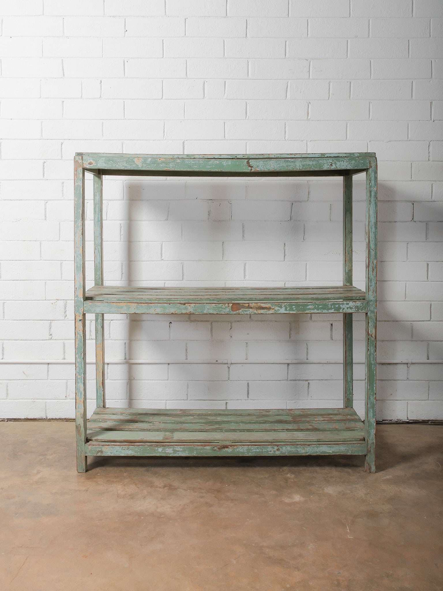 Rustic Painted Three-Tier Wood Shelf: Rectangular three-tier open shelving unit with distressed green painted finish and simple plank construction. Ideal for display or utility storage.