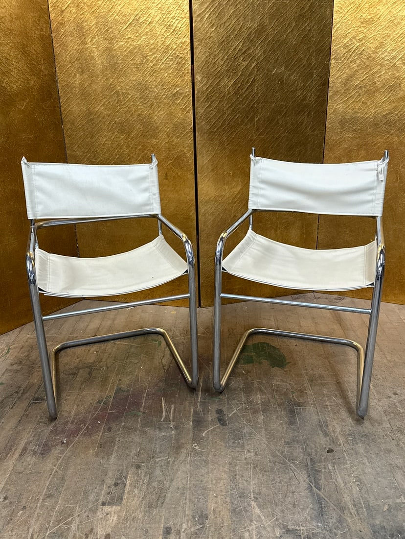 Pair of MCM Chrome & Leather Sling Chairs: Pair of modern sling-style chairs featuring polished chrome tubular frames with white leather sling seats and backs. The minimalist cantilever-inspired design offers a sleek, contemporary look with co
