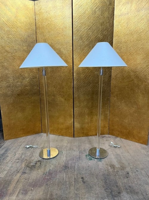 Pair of Modern Lucite and Chrome Floor Lamps: Pair of modern floor lamps featuring tall clear Lucite columns with polished chrome fittings and round chrome bases. Each lamp is topped with a clean-lined white shade, creating a sleek and minimalist