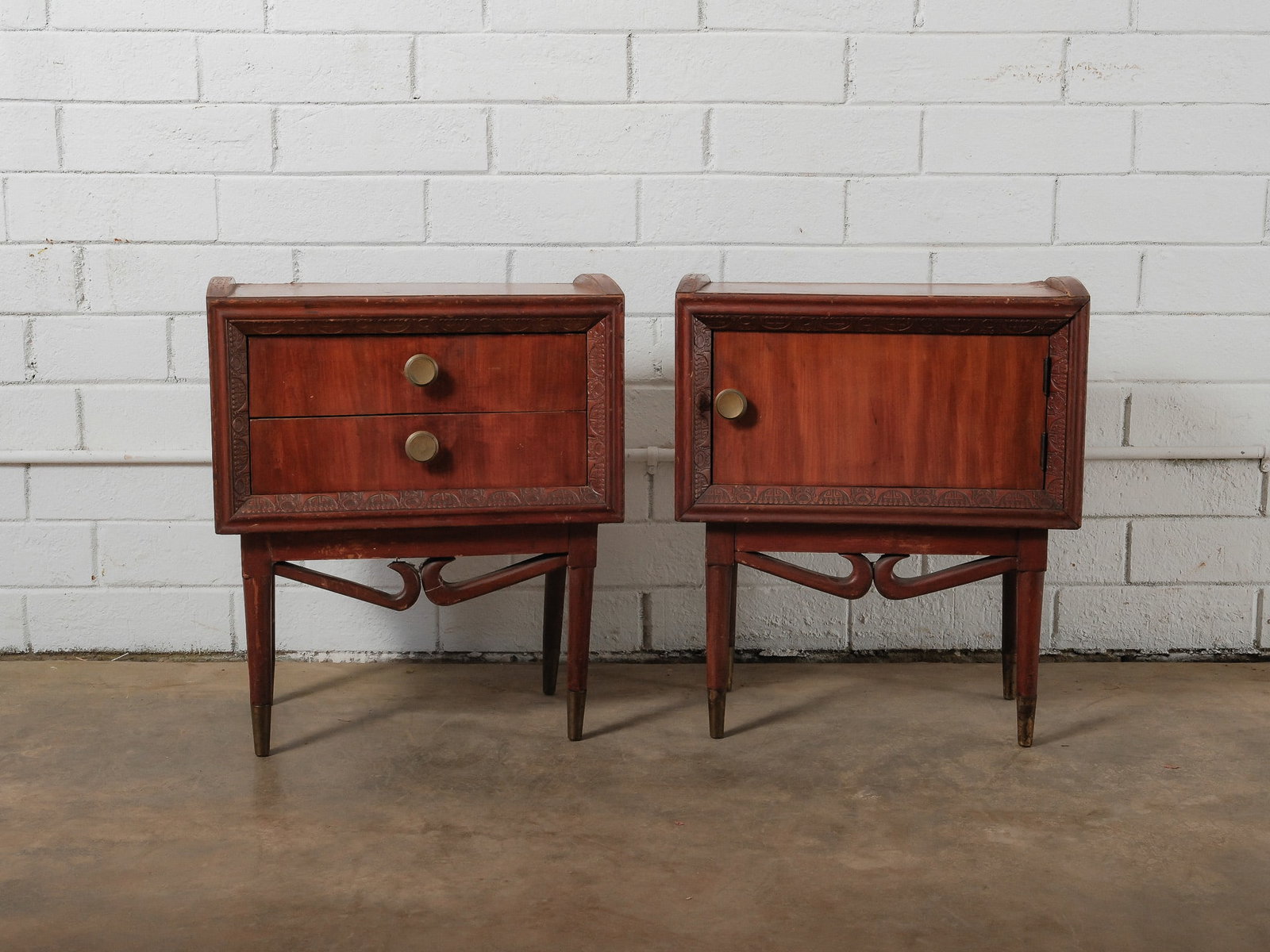 MCM Nightstands: A sculptural pair of mid-century modern nightstands featuring warm wood construction with carved decorative detailing along the case fronts. One nightstand offers two drawers, while the companion piec