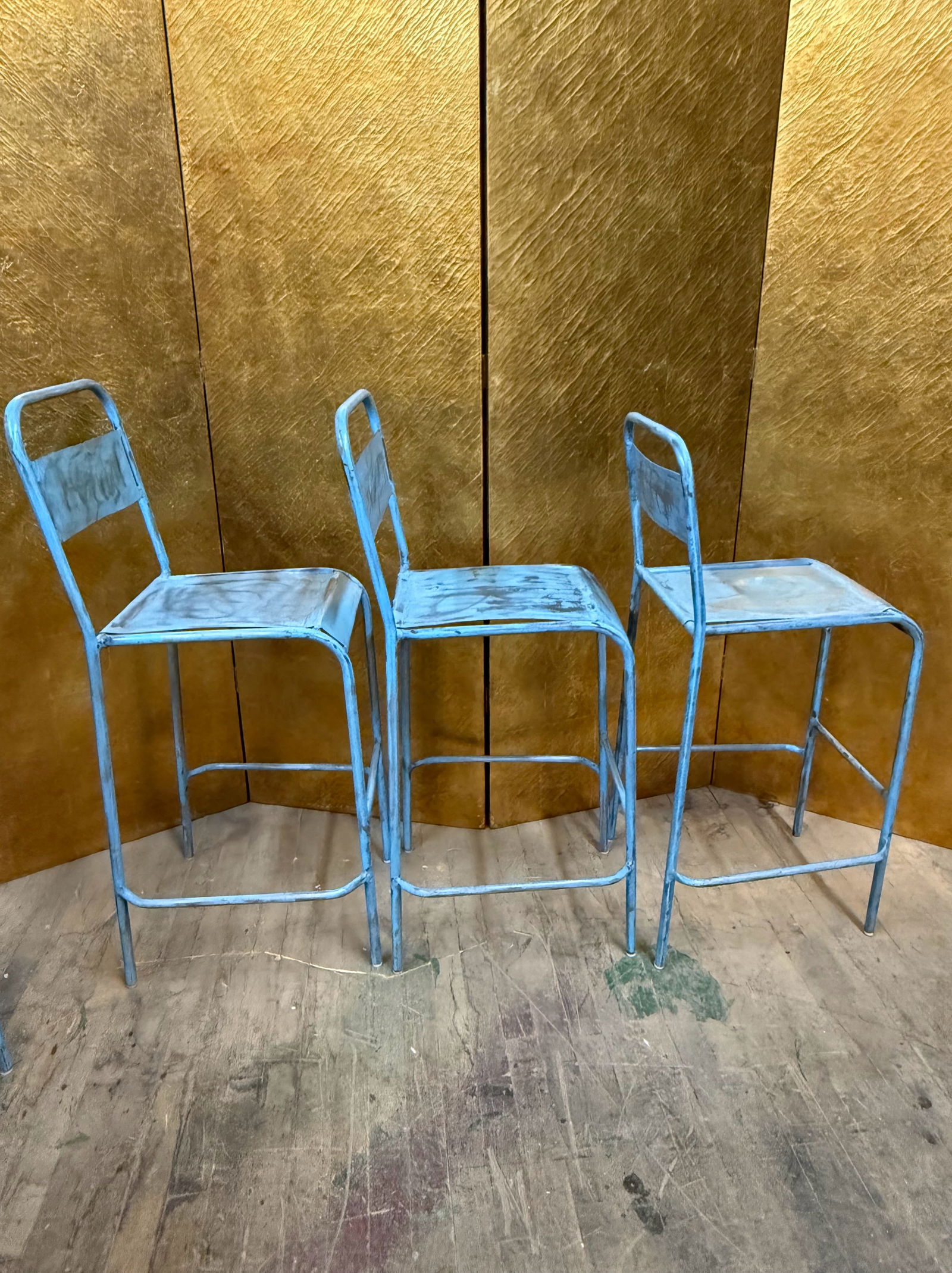 Set of 5 Stacking Blue Metal Industrial Counter Stools: Set of five industrial style metal counter height stools featuring tubular steel frames with rectangular metal backrests and seats. The stools display a distressed turquoise painted finish with areas