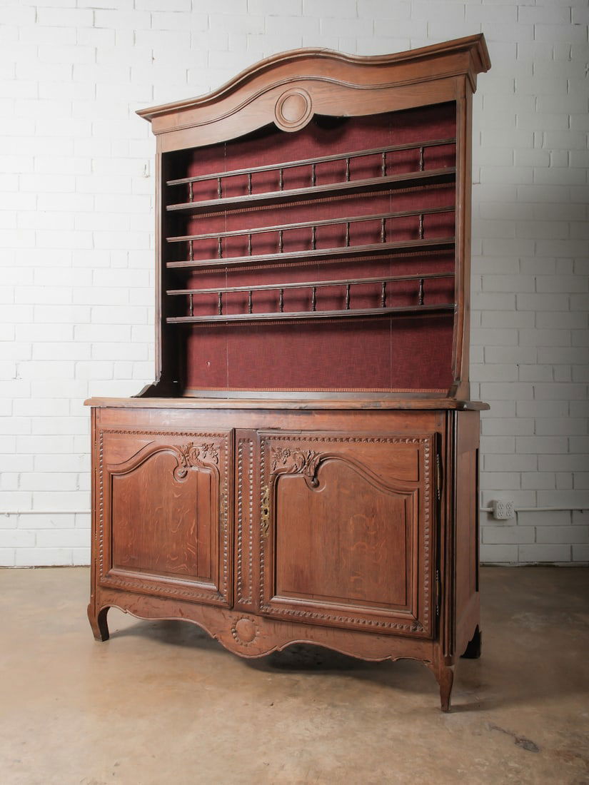 French Provincial Hutch: Two-piece hutch with shaped crest rail, open display shelving above, and paneled cabinet doors below. Carved decorative details and shaped apron.