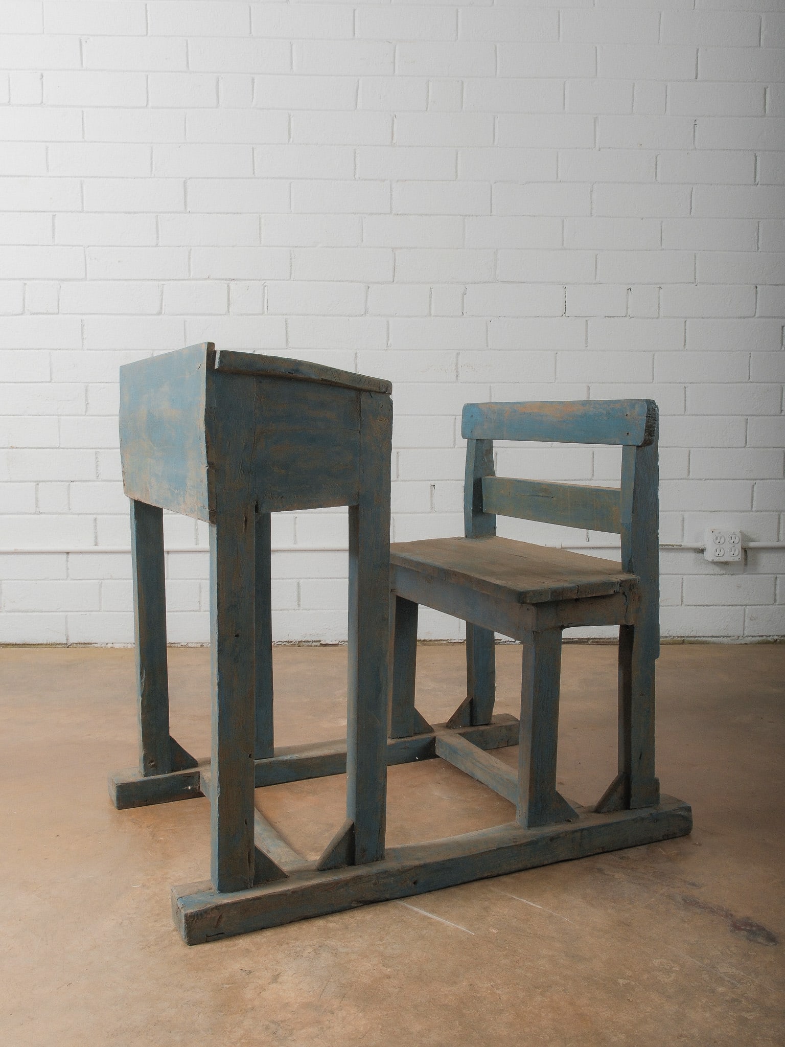 Primitive Painted School Desk and Chair: Rustic wooden school desk featuring attached bench seating and lift-top writing surface. Finished in a distressed blue-gray paint with visible wear and age. Strong primitive character ideal for farmho