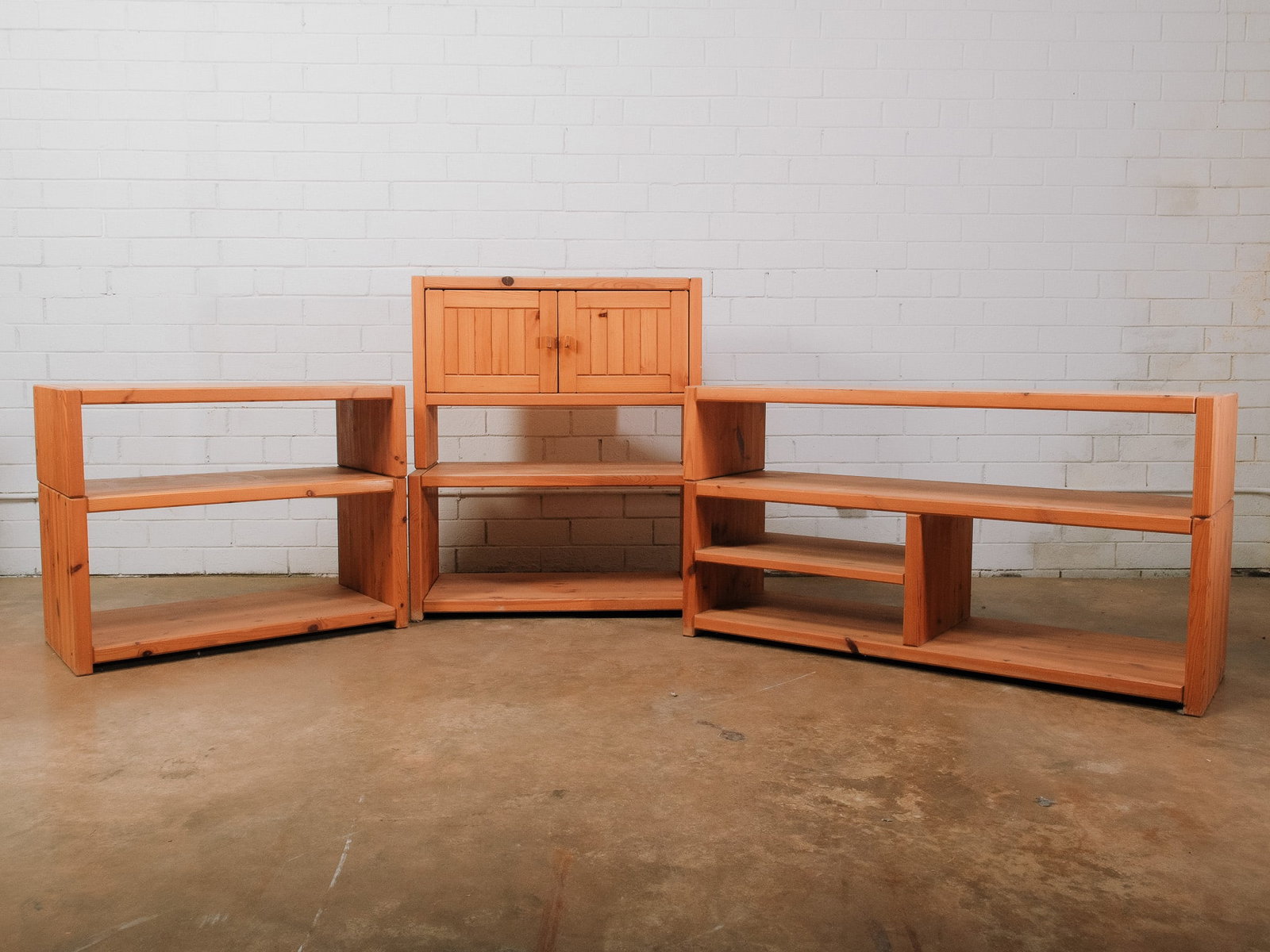 Modular Mid-Century Modern Stacking Wall Unit: Modular mid-century modern wall unit comprised of multiple interchangeable stacking components, including open shelving sections and a cabinet with double doors. Each unit is constructed in matching