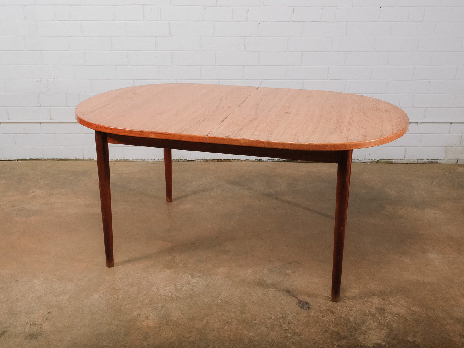 Oval MCM Dining Table: Simple oval dining table with tapered legs and a warm wood finish, offering a clean Scandinavian-inspired silhouette that complements both modern and mid-century interiors. Comfortably seats six and