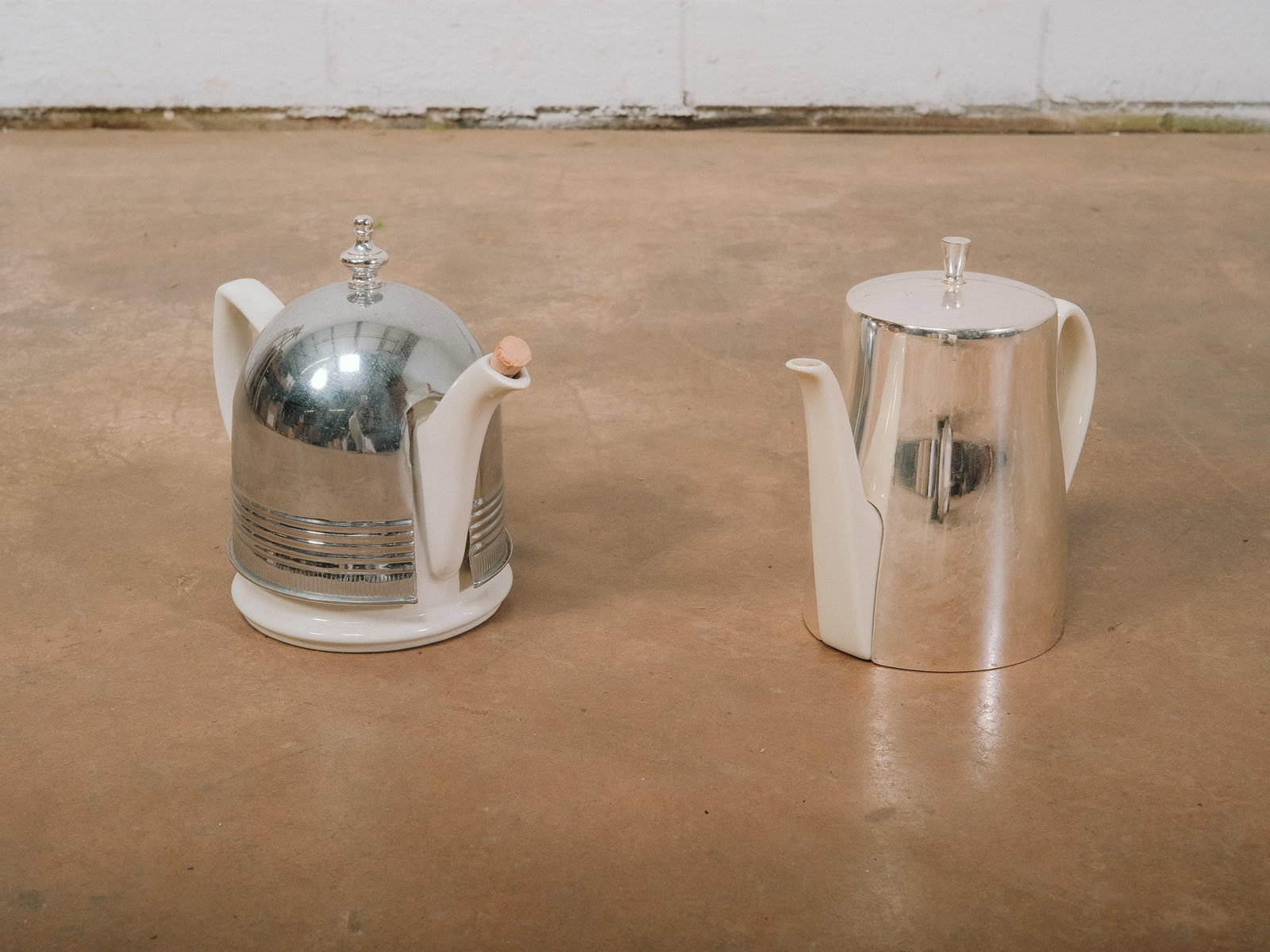 Pair of MCM Vintage Teapots: Collection of two modern teapots featuring sleek chrome and white finishes with minimalist styling. A stylish pairing for display or functional use, blending mid-century modern design with