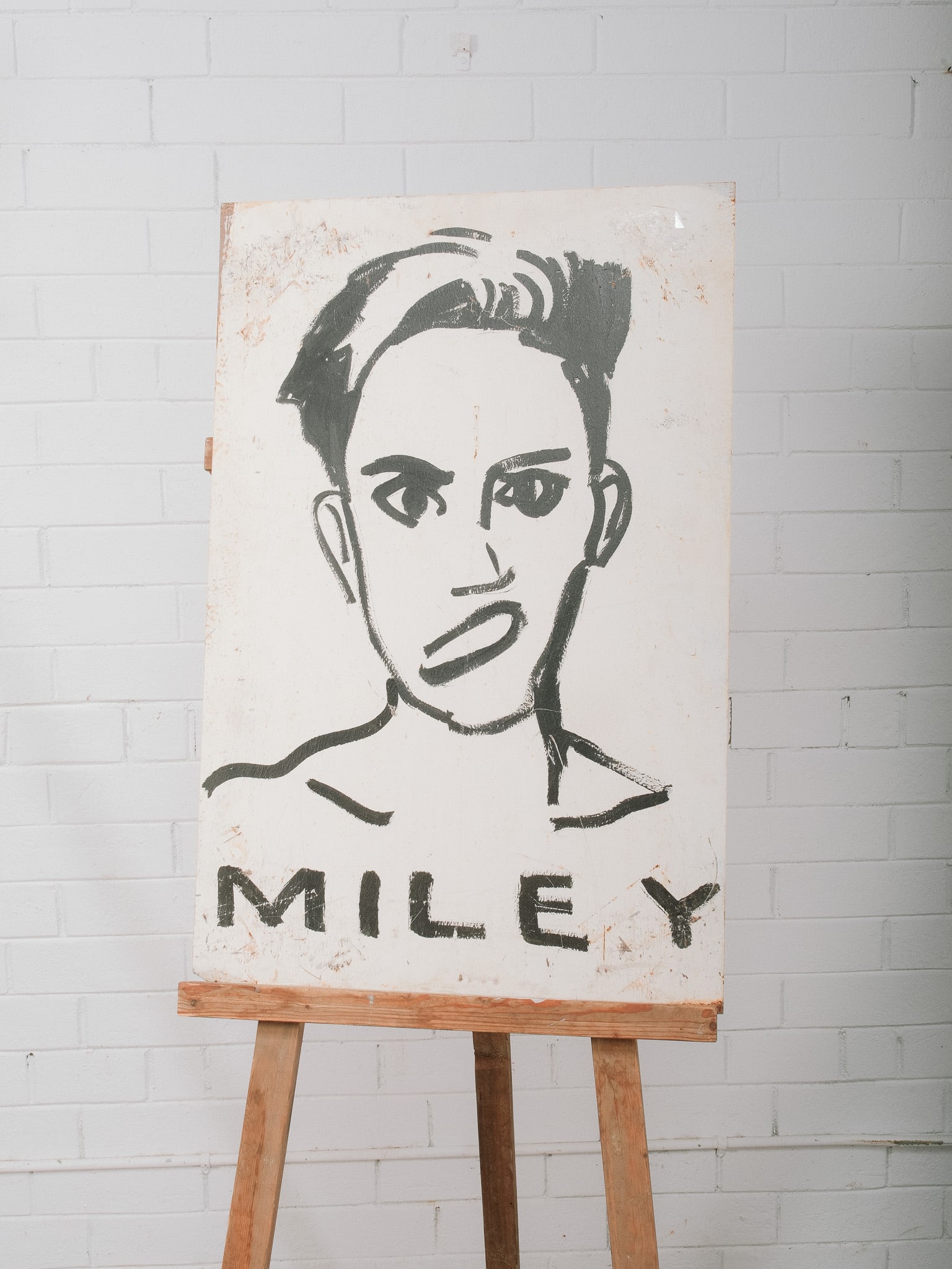 "Miley" Painting on Vintage Sheet Metal: Contemporary portrait painting depicting Miley Cyrus rendered in bold black and white brushwork with graphic lettering below. Hand painted on a vintage sheet metal panel, incorporating natural