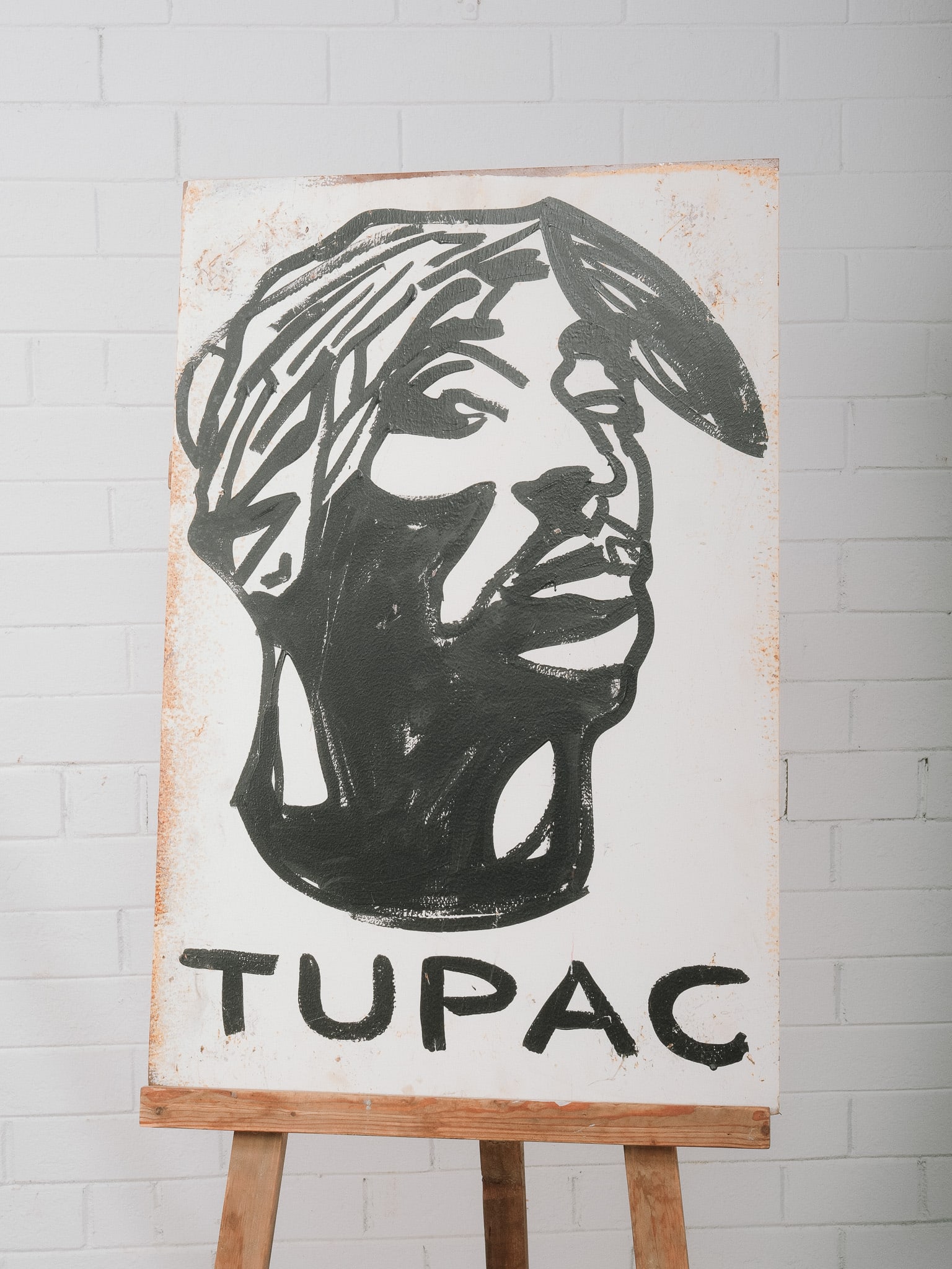 "Tupac" Painting on Vintage Sheet Metal: Contemporary portrait painting depicting Tupac Shakur in expressive black and white brushwork with bold lettering below. Hand painted on a vintage sheet metal panel, utilizing the natural patina and