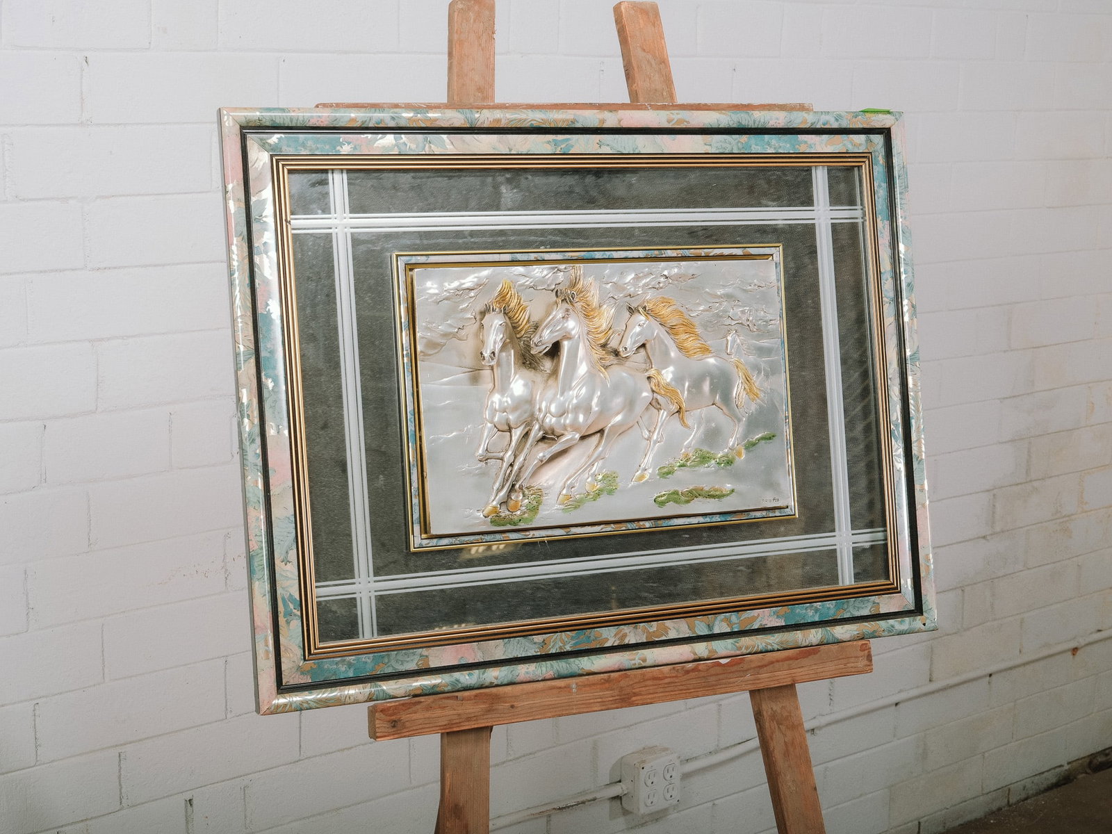 Decorative Embossed Horses Relief Wall Art with Mirrored Accents: Decorative wall art featuring an embossed relief of three galloping horses with metallic finishes and hand-painted accents. The relief is surrounded by mirrored panels, layered mats, and decorative