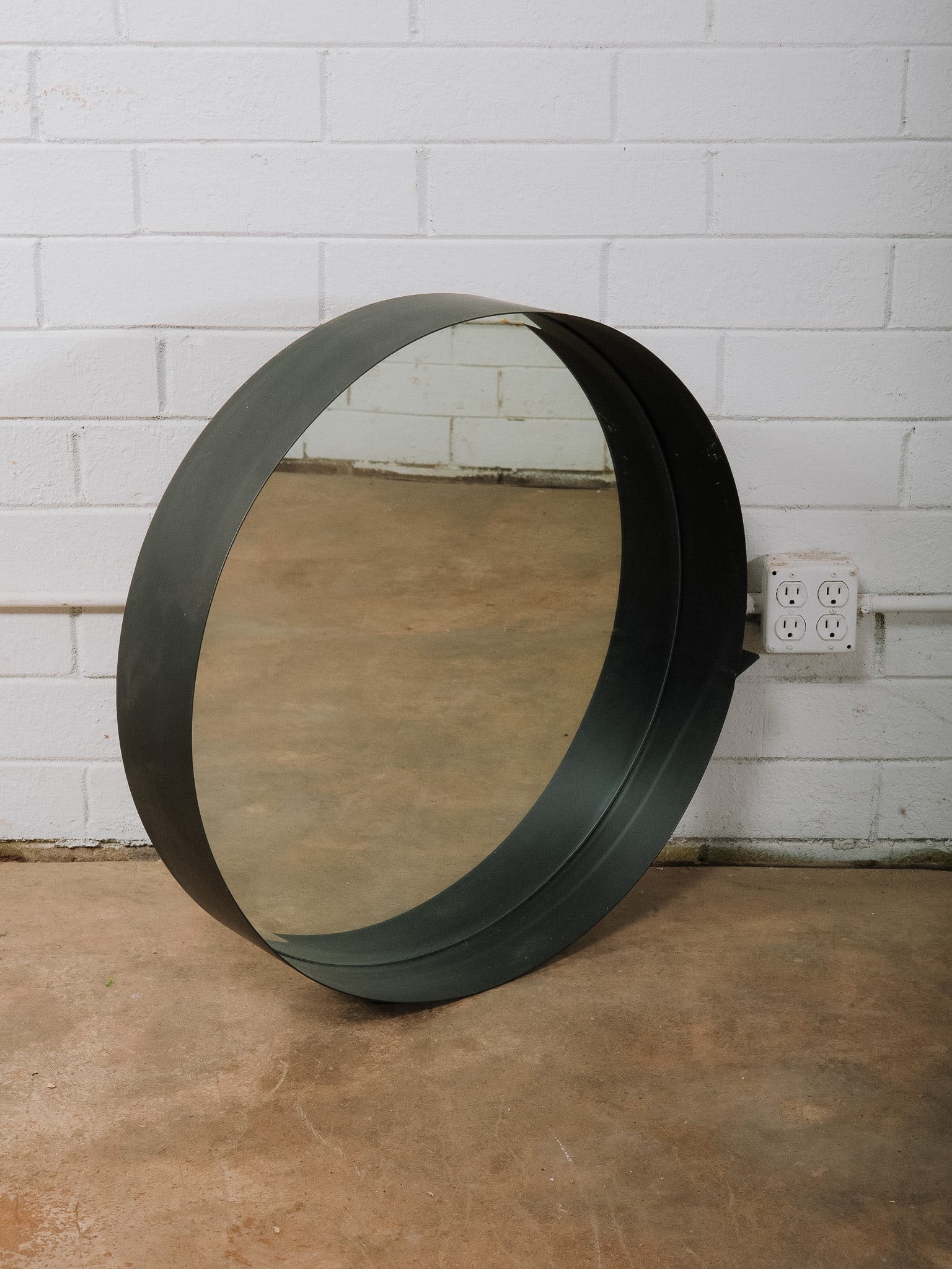 Modern Round Black Wall Mirror: Modern round wall mirror featuring a deep black metal frame with a clean minimalist profile. It's simple contemporary design makes it ideal for an entryway, bathroom, bedroom, or living
