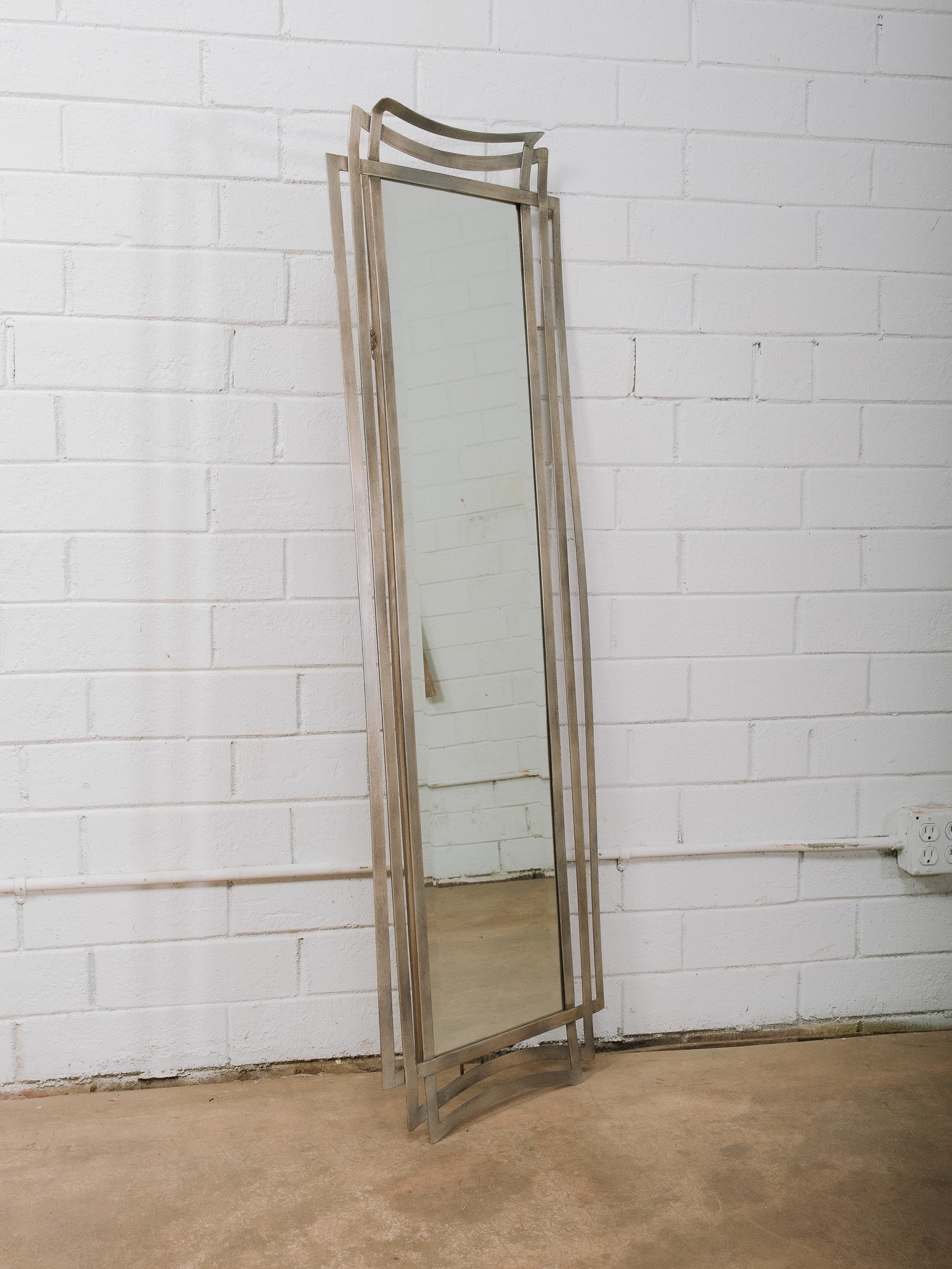 Modern Brushed Aluminum Floor Mirror: Tall modern floor mirror featuring a brushed aluminum frame with gently curved top and bottom rails. Its clean minimalist design makes it ideal for a bedroom, dressing area, or contemporary