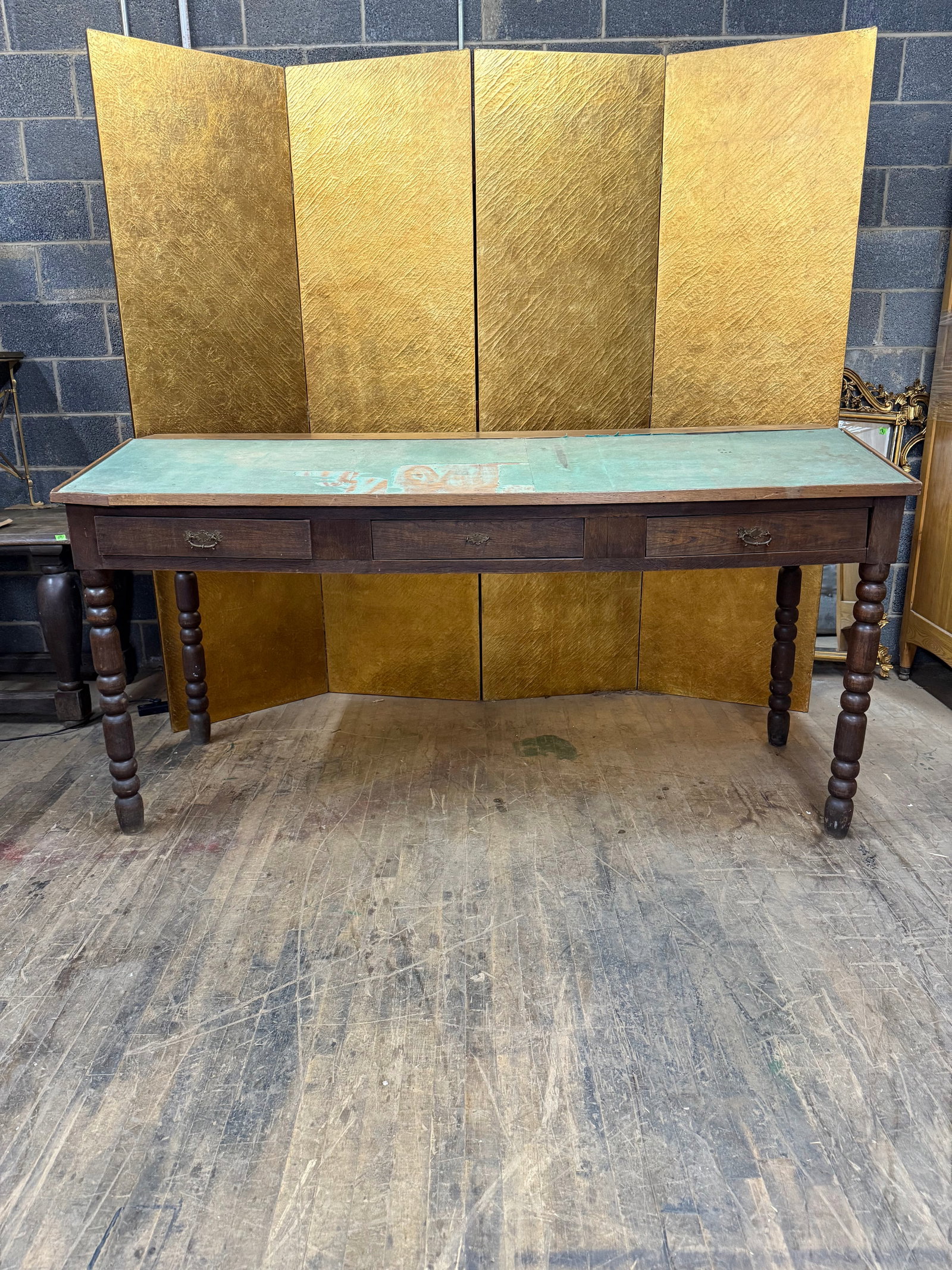 Large Writing Desk with Angled Felt Top: Large wooden writing desk featuring a distinctive angled felt writing surface in a green tone. The rectangular form includes three front drawers fitted with decorative metal pulls for convenient