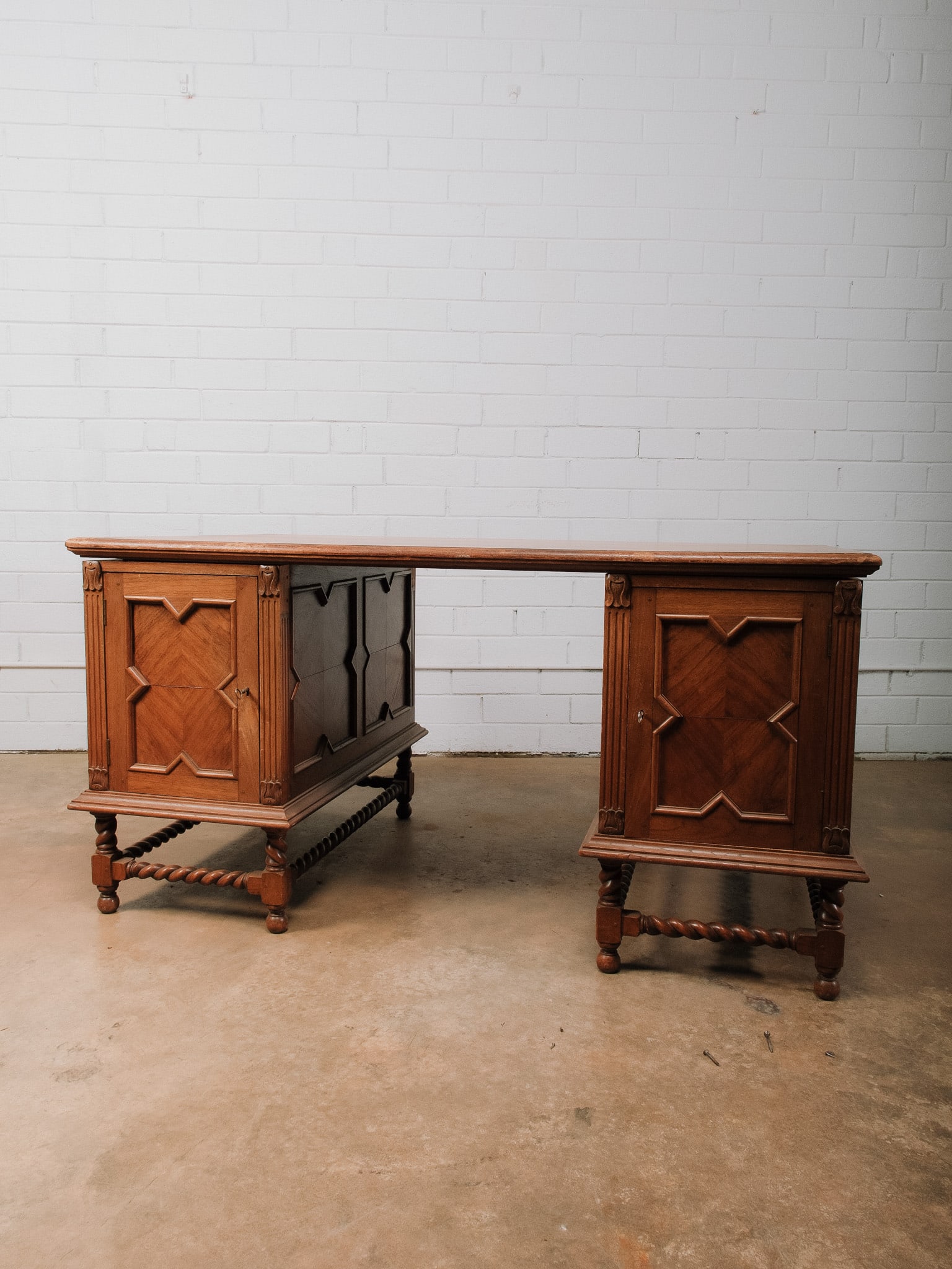 English Oak Partners Desk: Substantial English oak partners desk featuring a spacious work surface, paneled cabinet pedestals with versatile interior storage, and classic barley twist stretchers and legs. The traditional