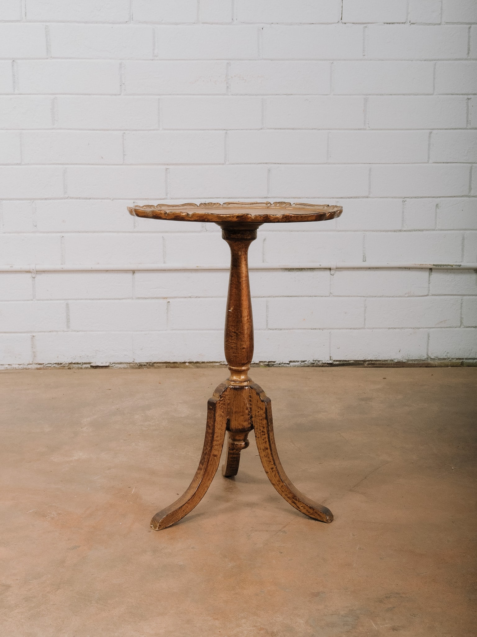 Venetian Style Round Painted Accent Table: Venetian style round accent table featuring a shaped painted top over a turned pedestal supported by three splayed legs with gilt accents. The distressed finish and elegant silhouette make it ideal