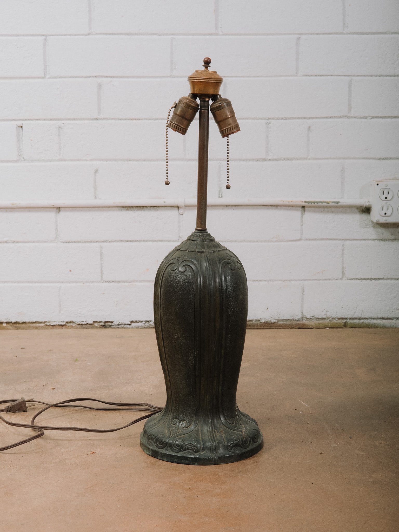 Art Nouveau Style Cast Metal Lamp Base: Art Nouveau style cast metal table lamp base featuring flowing organic relief decoration and a rich verdigris finish. Fitted with dual pull-chain sockets and ready for your choice of shade.Approximate
