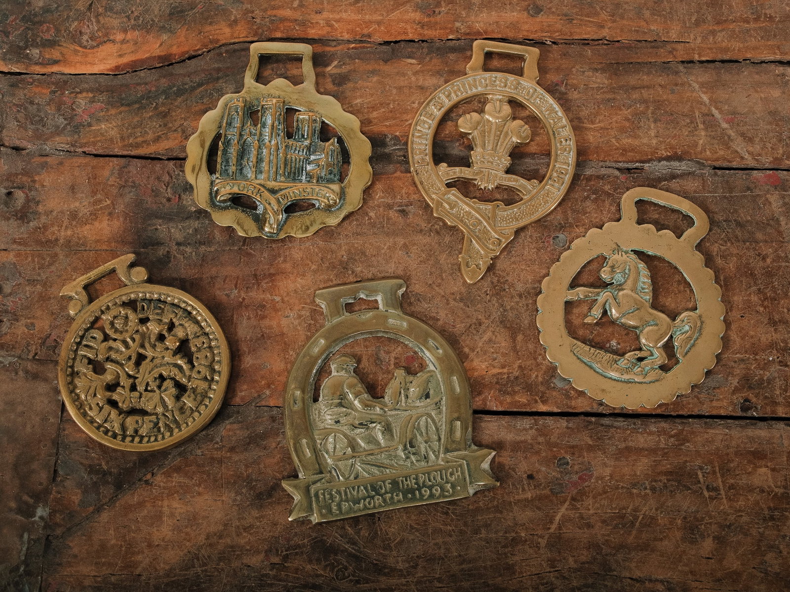 English Horse Brasses #2: Collection of five English horse brasses featuring assorted traditional designs, including horseshoes and decorative motifs. Originally used as ornamental harness decorations for working horses,