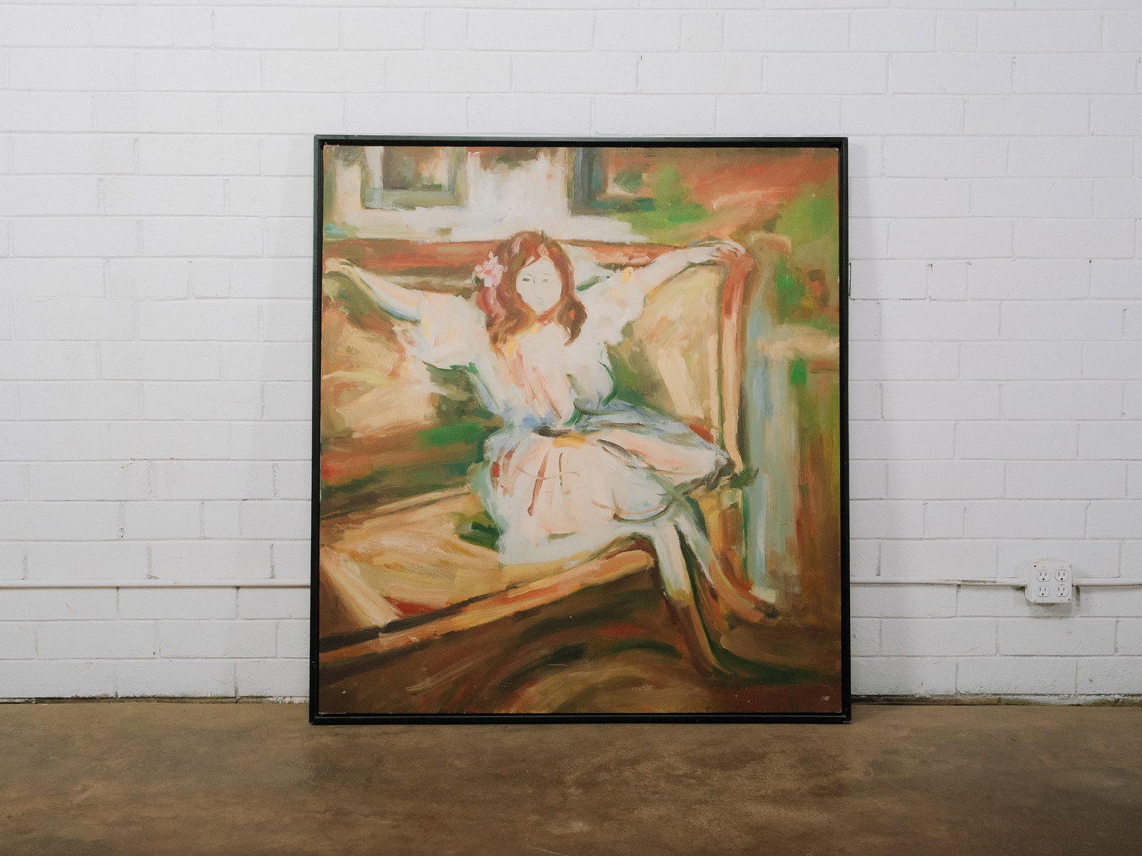 Contemporary Figural Oil on Canvas: Large contemporary oil on canvas depicting a seated female figure rendered in expressive, loose brushstrokes with warm earth tones and soft greens. Presented in a slim black frame, the composition