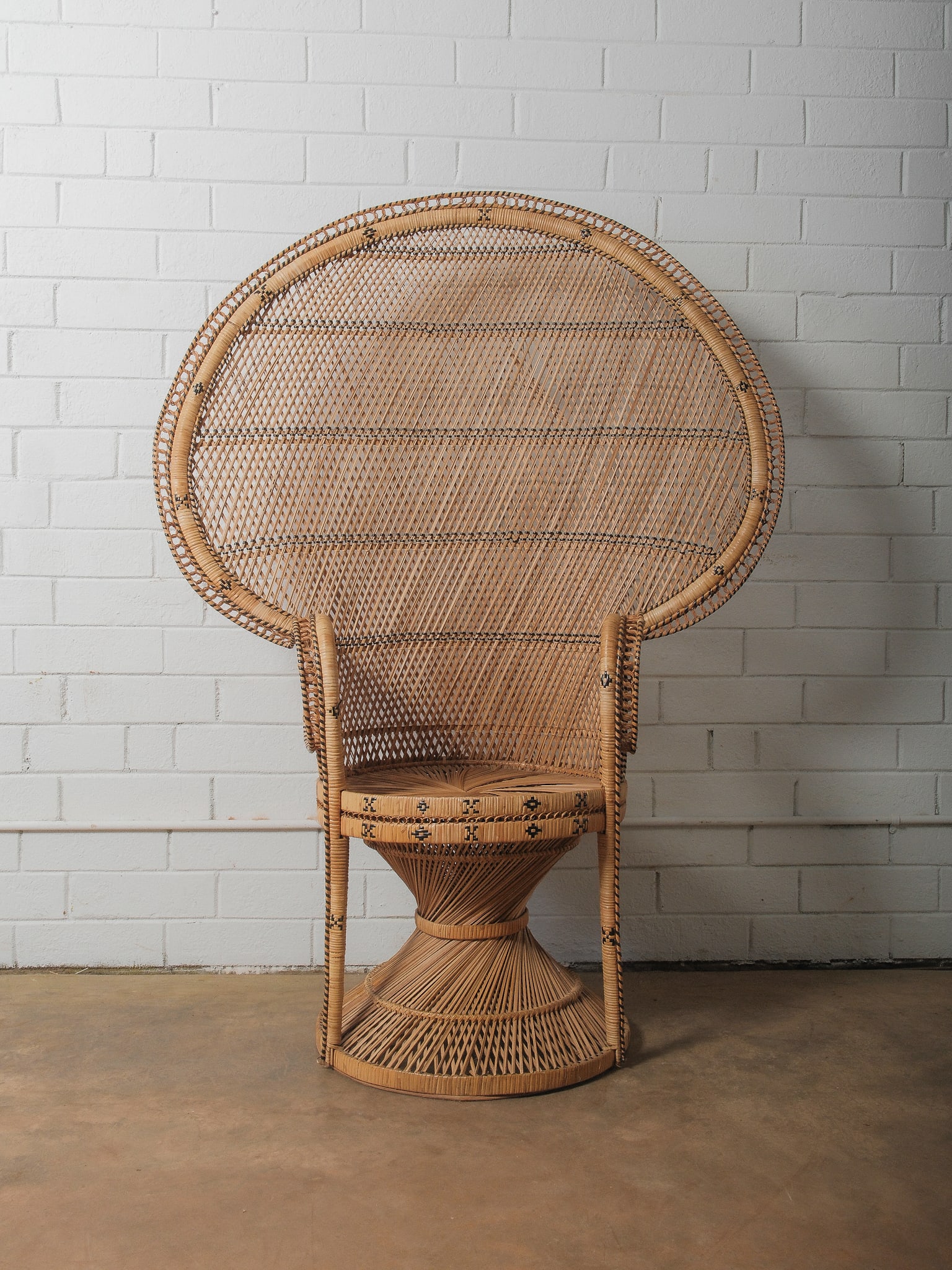 Vintage Bohemian Wicker Peacock Chair.: Iconic handwoven Italian rattan peacock chair from the 1960s. With wide fan-shaped back, intricate lattice weave, and sculptural hourglass base. Natural honey-toned finish with subtle darker accents