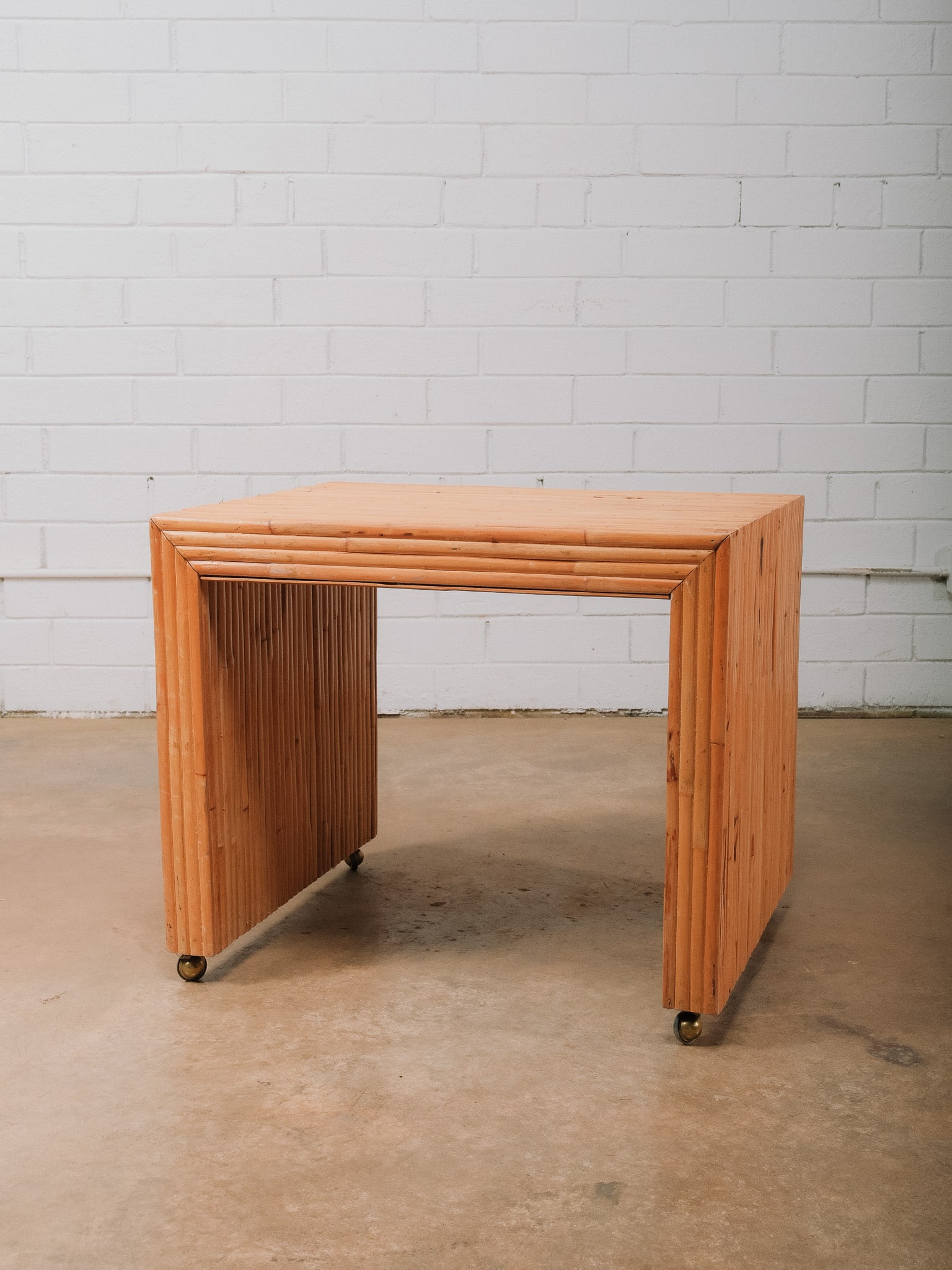 Bamboo Side Table with Brass Ball Feet: Bamboo side table featuring a sculptural waterfall-inspired design with vertically arranged bamboo throughout and distinctive brass ball feet. The clean architectural lines and warm natural finish