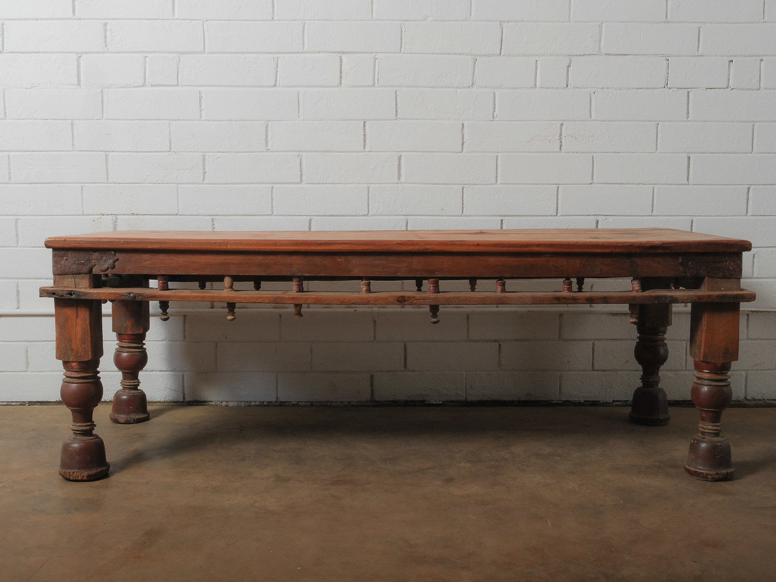 Antique Anglo-Indian Teak Table: Introducing this exquisite vintage coffee table, a captivating blend of rustic charm and exceptional craftsmanship. Its generous surface area is ideal for showcasing books, decorative pieces, or servi