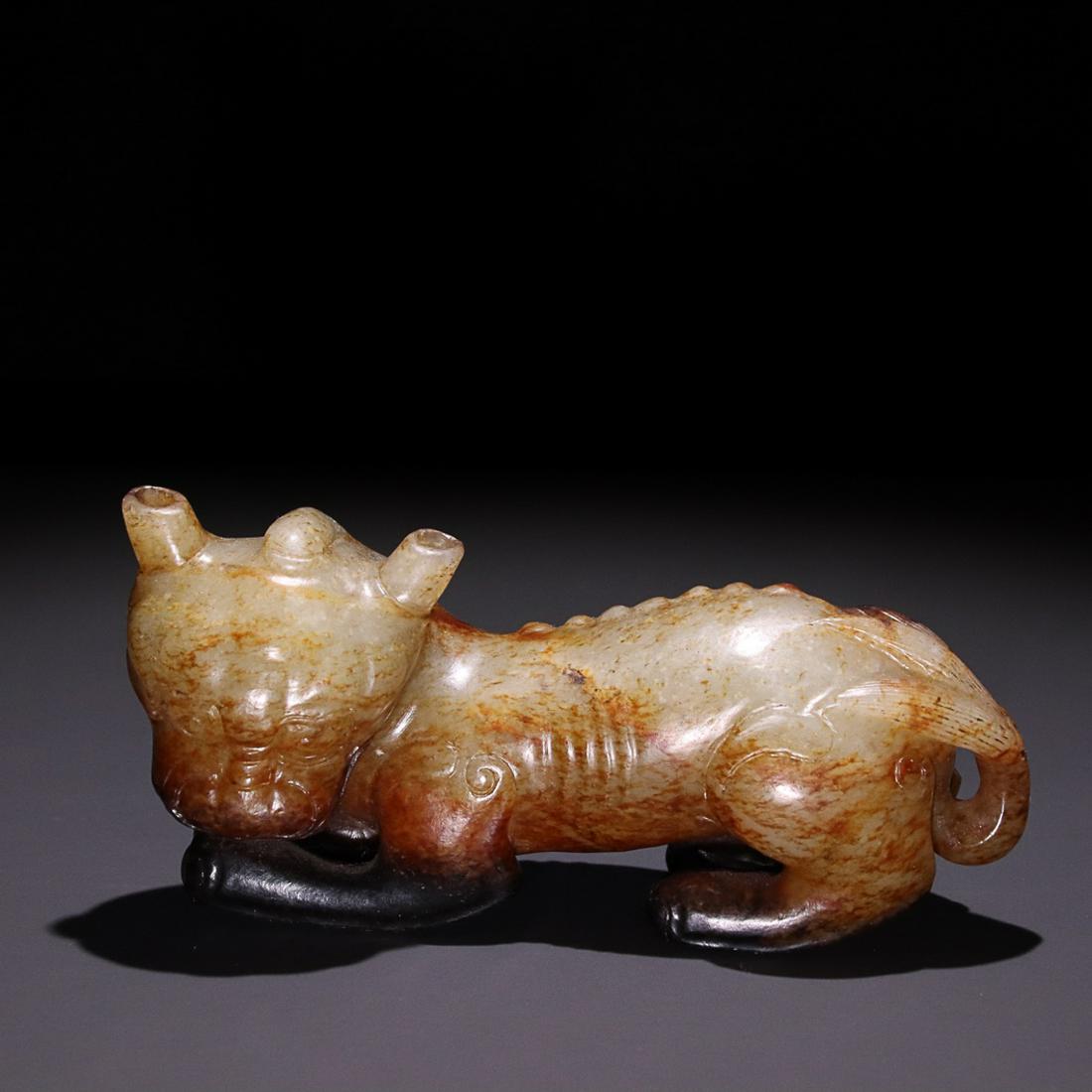 HETIAN JADE 'AUSPICIOUS BEAST' CARVING: Associated Time: Ming Dynasty 14-17 Century / Height 5.8cm/ Width 11.5cm/ Weight 322g/ Description Statement: Any description statement is given as a courtesy to a client, is an opinion and should not