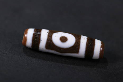 DZI BEAD: 39.3*11.1mm Description Statement: Any description statement is given as a courtesy to a client, is an opinion and should not be treated as a statement of fact and Merces Gallery shall have no
