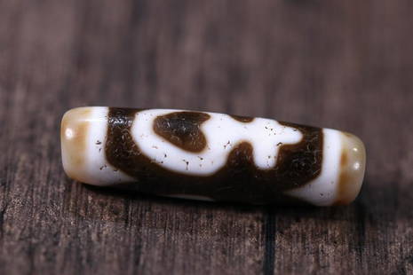 DZI BEAD: 42.2*11.7mm Description Statement: Any description statement is given as a courtesy to a client, is an opinion and should not be treated as a statement of fact and Merces Gallery shall have no