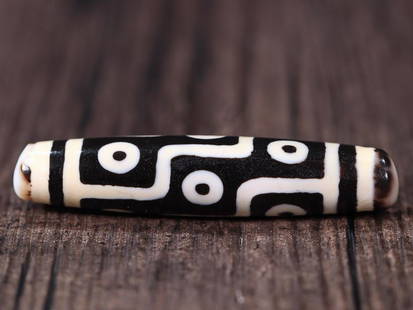 DZI BEAD: 6.15*1.28cm Description Statement: Any description statement is given as a courtesy to a client, is an opinion and should not be treated as a statement of fact and Merces Gallery shall have no
