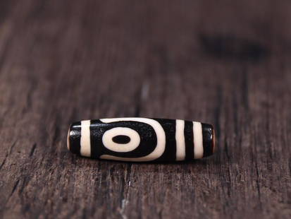 DZI BEAD: 4.2*1.27cm Description Statement: Any description statement is given as a courtesy to a client, is an opinion and should not be treated as a statement of fact and Merces Gallery shall have no