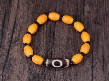 YELLOW SHERPA GLASS BEADED BRACELET WITH DZI BEAD: Dzi Bead 2.8*1.19cm Description Statement: Any description statement is given as a courtesy to a client, is an opinion and should not be treated as a statement of fact and Merces Gallery shall have