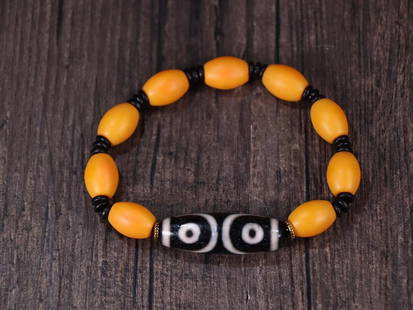 YELLOW SHERPA GLASS BEADED BRACELET WITH DZI BEAD: Dzi Bead 3.69*1.22cm Description Statement: Any description statement is given as a courtesy to a client, is an opinion and should not be treated as a statement of fact and Merces Gallery shall have