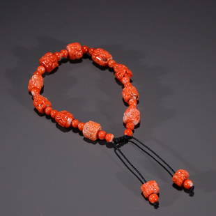 CHINESE CORAL BEADED BRACELET WITH CARVED 'RUYI': Diameter: 1X1.1cm. Weight: 17g Description Statement: Any description statement is given as a courtesy to a client, is an opinion and should not be treated as a statement of fact and Merces Gallery