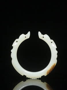 HETIAN WHITE JADE BANGLE WITH CARVED 'BEASTS': Width 0.7cm/ Outer-Diameter 7.2cm/ Inner-Diameter 5.3cm/ Weight 0.003kg Description Statement: Any description statement is given as a courtesy to a client, is an opinion and should not be treated