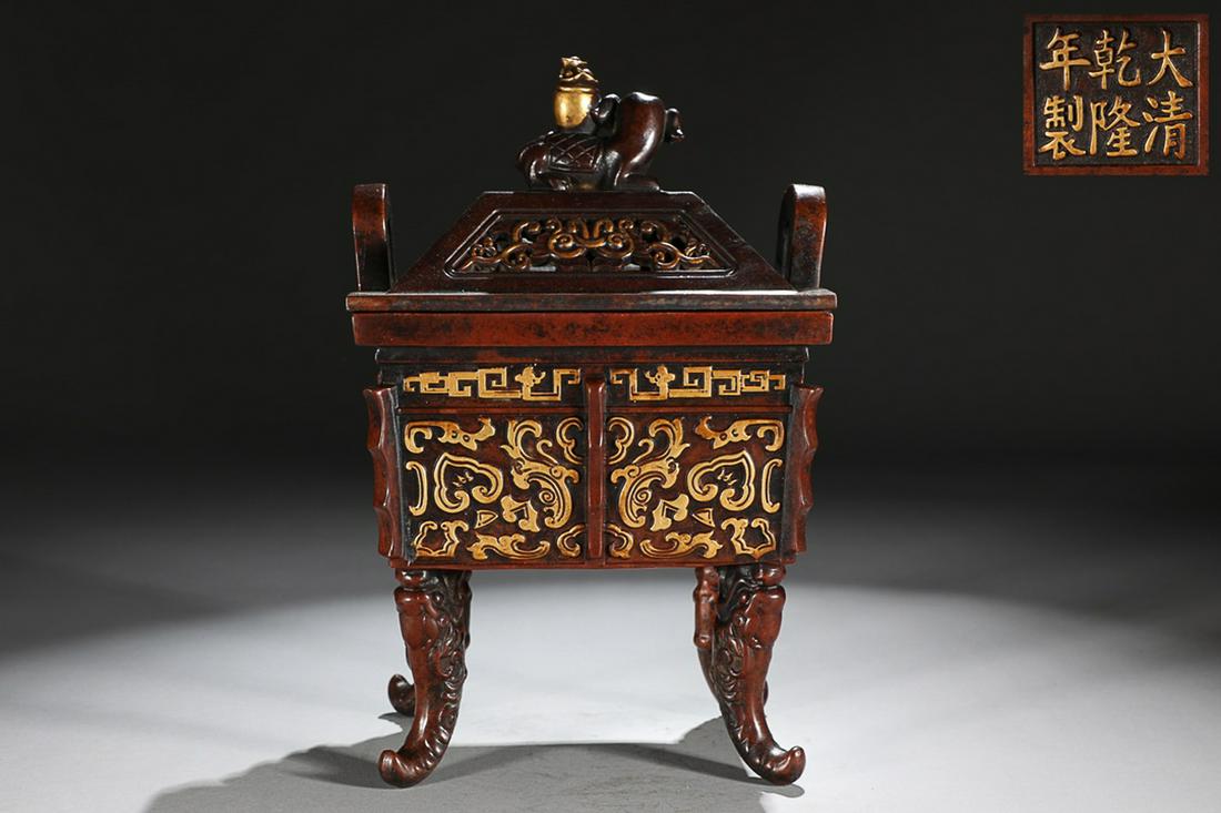 CHINESE BRONZE HANDLED DING-FORM INCENSE BURNER WITH CARVED 'ANIMAL MASK', 'QING QIANLONG' MARK: Height: 26cm, Mouth-Diameter: 12.5x16.4cm. Weight: 5.1kg Description Statement: Any description statement is given as a courtesy to a client, is an opinion and should not be treated as a statement of 