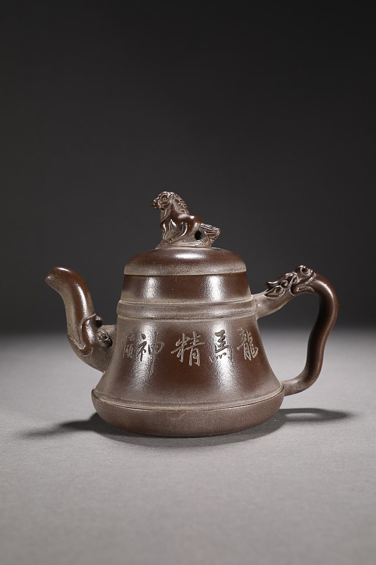 CHINESE ZISHA TEAPOT, 'LONG MA JING SHEN', 'WU YUN' MARK: 17.5x11x12cm. Weight: 0.38kg Description Statement: Any description statement is given as a courtesy to a client, is an opinion and should not be treated as a statement of fact and Merces Gallery shal