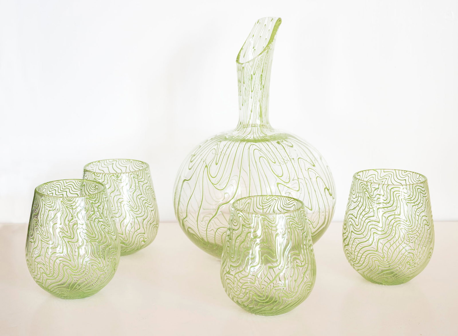 BRAD PEARCE (American/Texas 21st Century) A GLASS DECANTER SET: BRAD PEARCE (American/Texas 21st Century) Decanter Set with 4 glasses Decanter signed on the bottom and dated 2016 Decanter - 10 tall x 6 1/2 diameter inches Documentation from Texas Monthly provided 