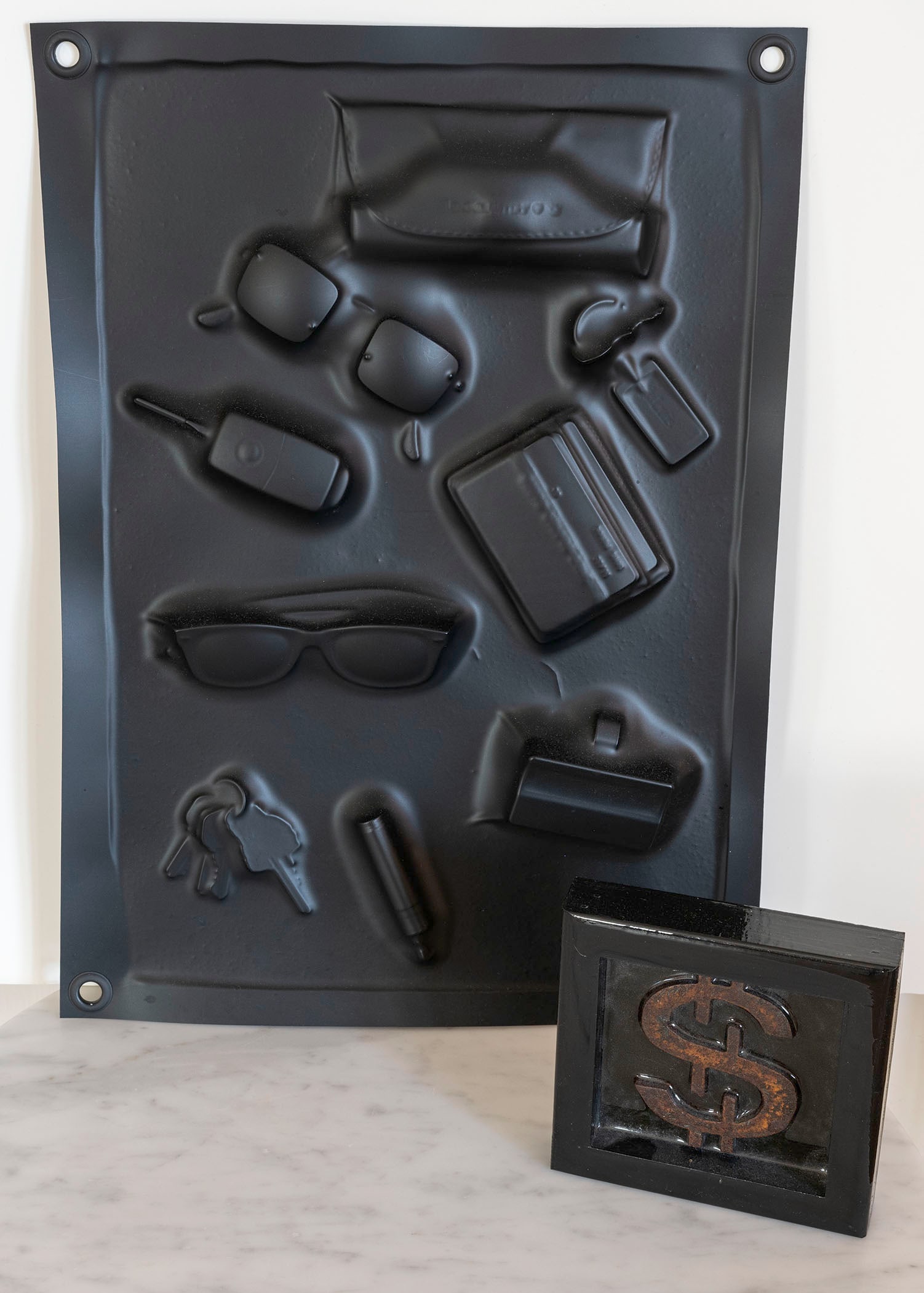 GREG REUTER (American/Texas 20th/21st Century) TWO SCULPTURES: GREG REUTER (American/Texas 20th/21st Century) "$" Metal in resin 5 7/8 x 5 7/8 x 1 1/4 inches and "Luis's Shit" Extruded vacuum formed plastic 20 x 14 1/4inches Proceeds from this auction benefit the