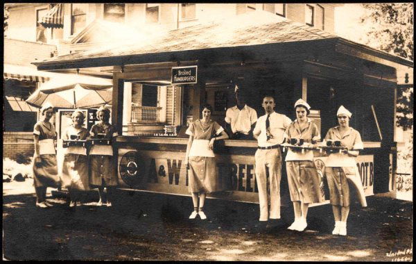 Early A&W Root Beer Stand: August 1917. Great image of the six waitresses standing out front with trays of root beer. The man behind the counter is either a customer, or more likely the owner. Out front