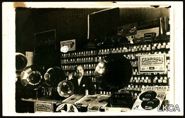 RPPC Early Columbia Phonograph Record Store Fa: RPPC Early Columbia Phonograph Record Store Fantastic interior of store with horn record players and lots of cylinder record inventory. Stains at top edge. 1
